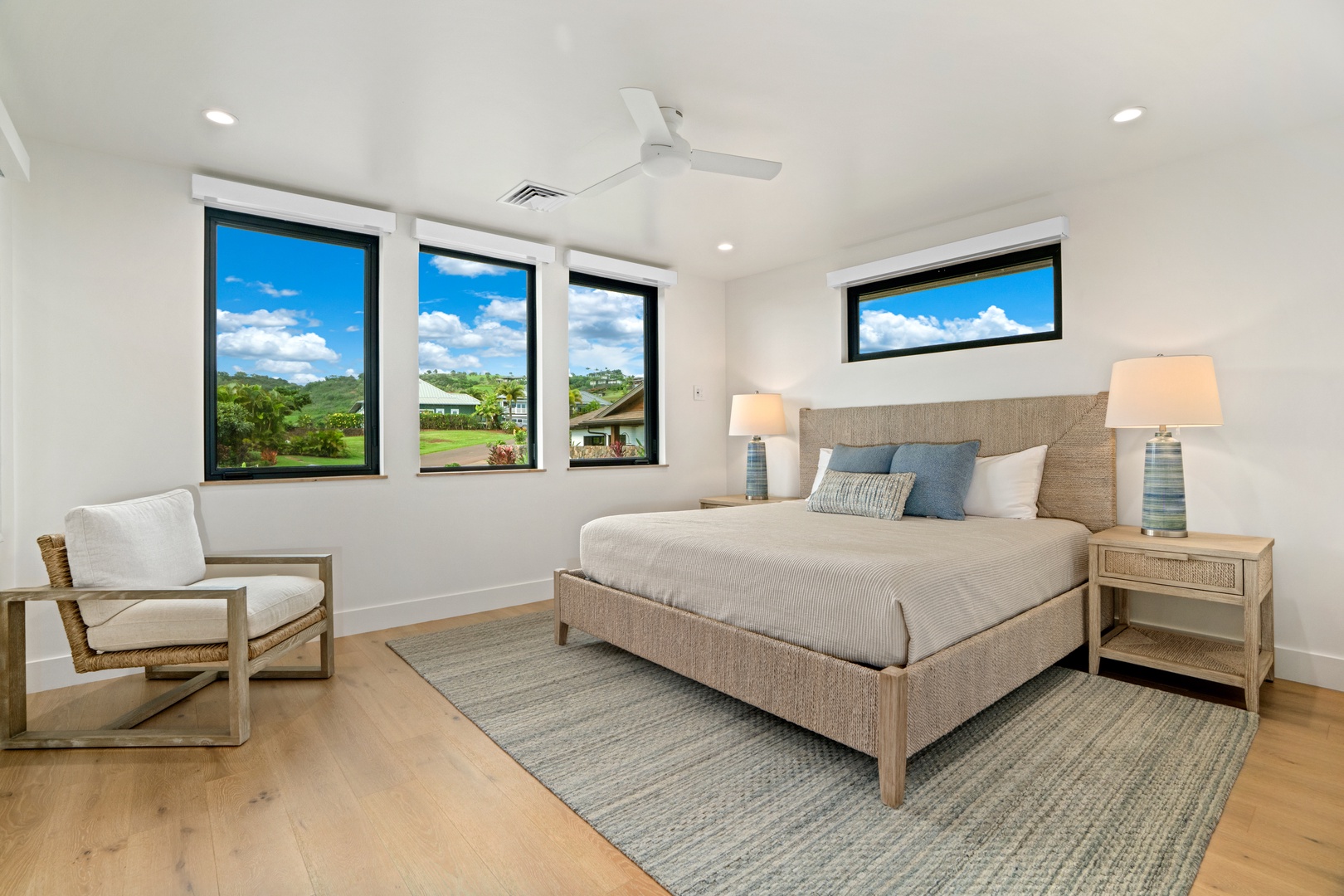Koloa Vacation Rentals, Hale Laule'a at Kukui'ula - Wake up to breathtaking views from your serene bedroom, where natural light streams through expansive windows showcasing rolling green landscapes.