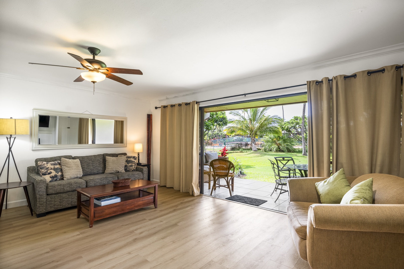 Kihei Vacation Rentals, Koa Resort 1B - Sink onto the sofa with the sliders wide open to enjoy tropical views where the manicured green lawn meets the lanai