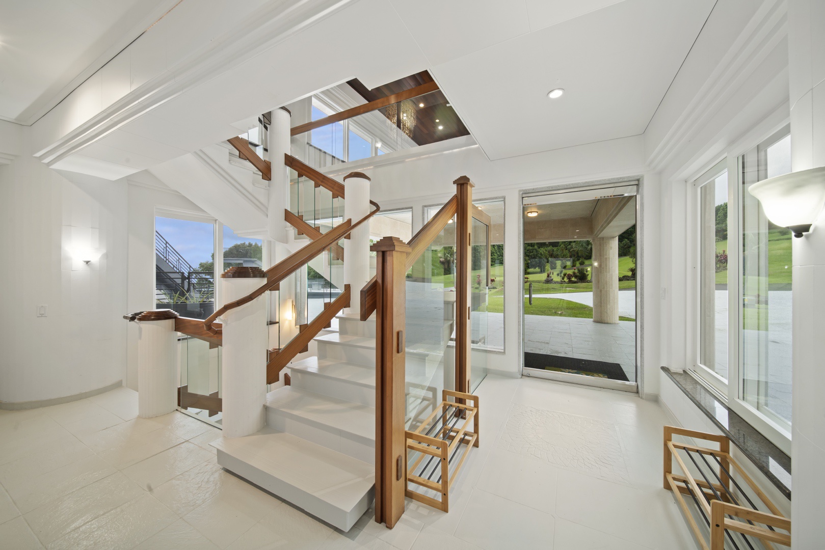 Ninole Vacation Rentals, Waterfalling Estate - Front entrance featuring spiral staircase between floors.