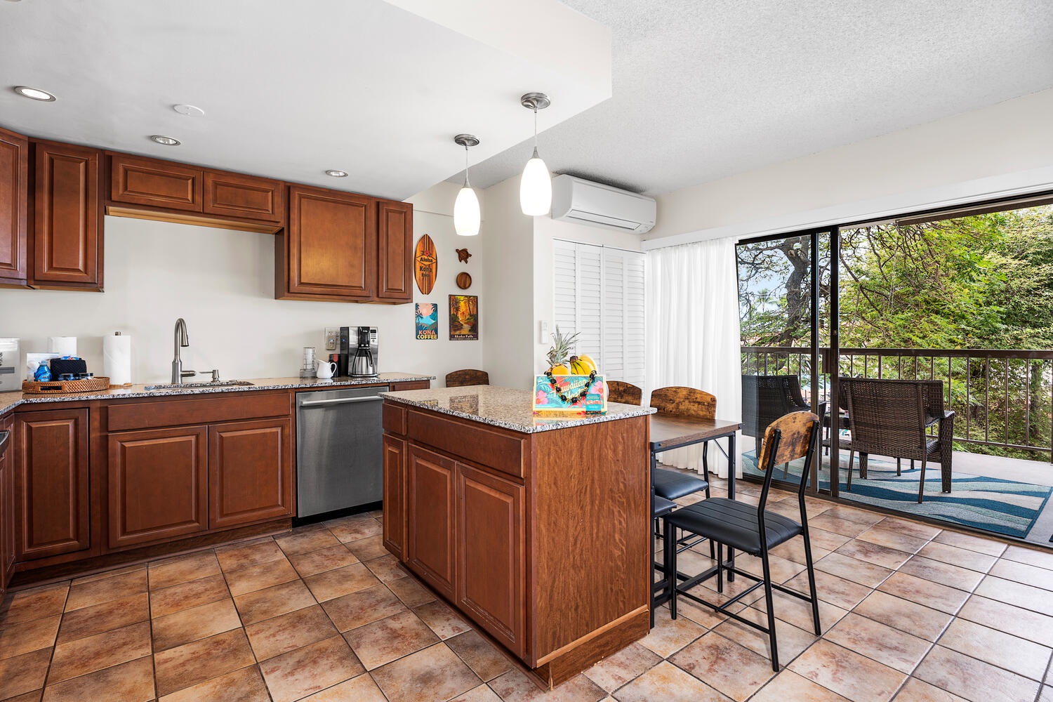 Kailua Kona Vacation Rentals, Kona Plaza 201 - Your open kitchen features granite countertops, rich wood cabinetry, and flows seamlessly to your private lanai with garden views.