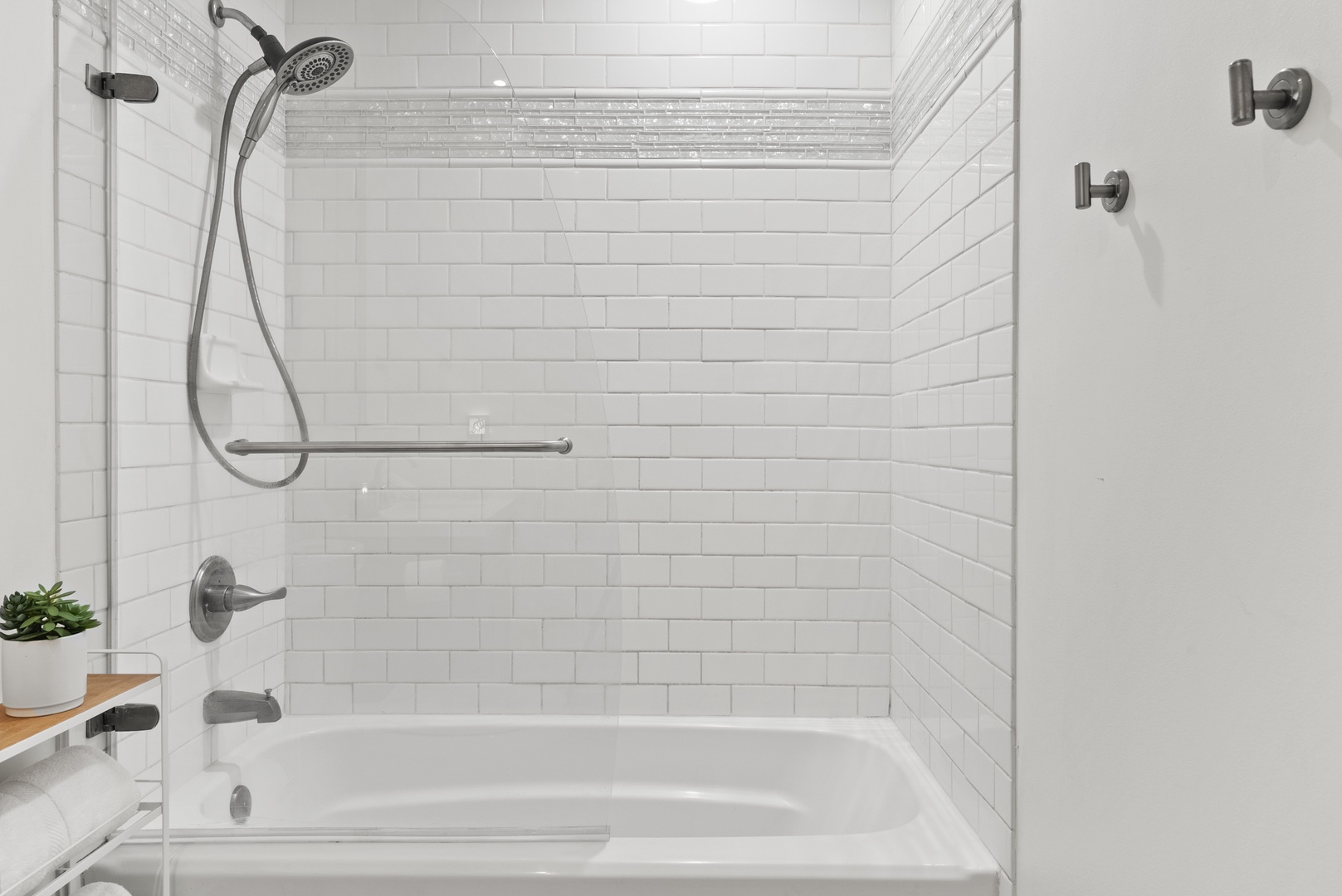 Kaaawa Vacation Rentals, Ka'a'awa Hale - Elegant shower and tub with classic white subway tile for a fresh, modern look.