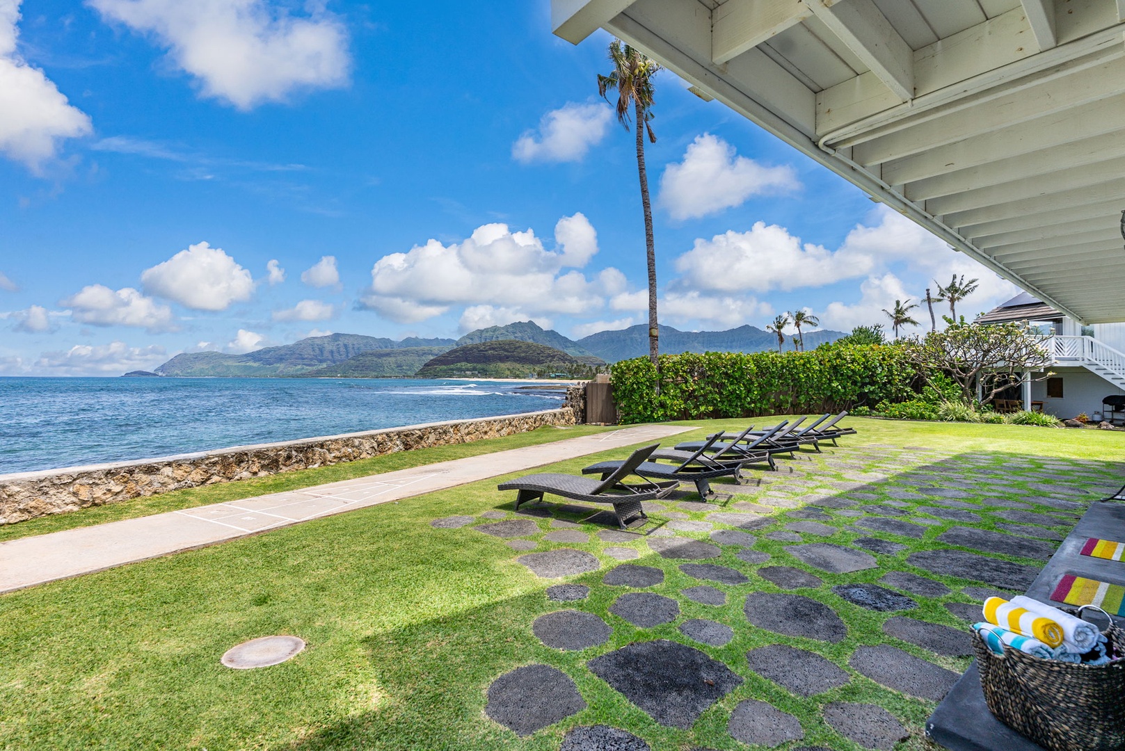 Waianae Vacation Rentals, Ma'ili Blue Estate - Breathtaking oceanfront paradise with your private lawn leading to pristine waters, where loungers await and mountain views create the perfect backdrop.