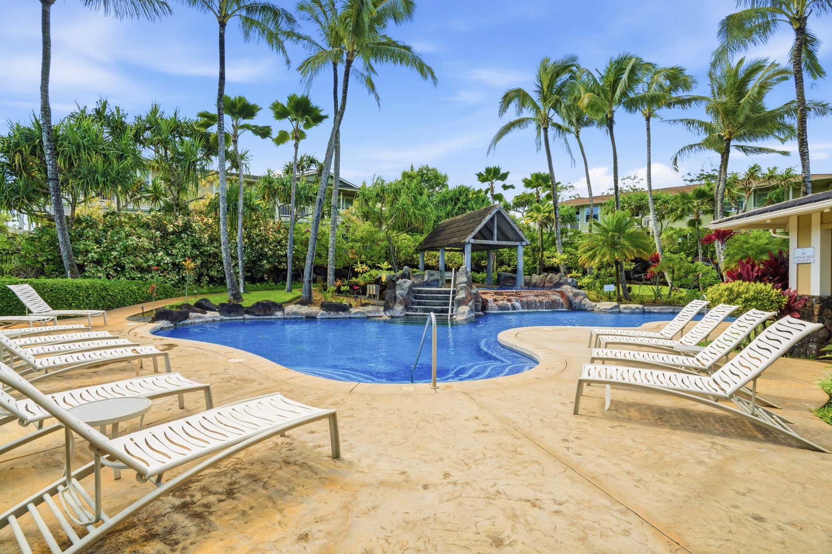 Princeville Vacation Rentals, Hale Kaua'i - Cool off in the sparkling pool surrounded by tropical palms and lush island landscaping.