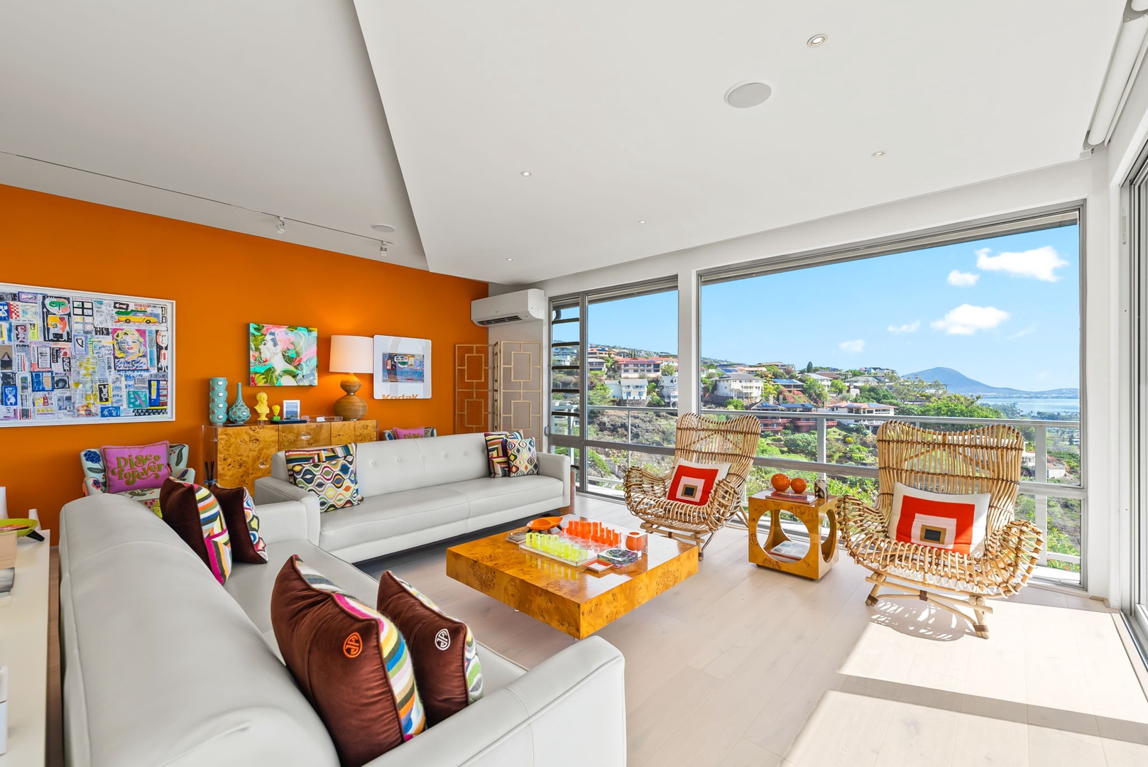 Honolulu Vacation Rentals, Kahala Hills Estate - Contemporary upstairs living room with statement art, warm accents, and floor-to-ceiling windows.