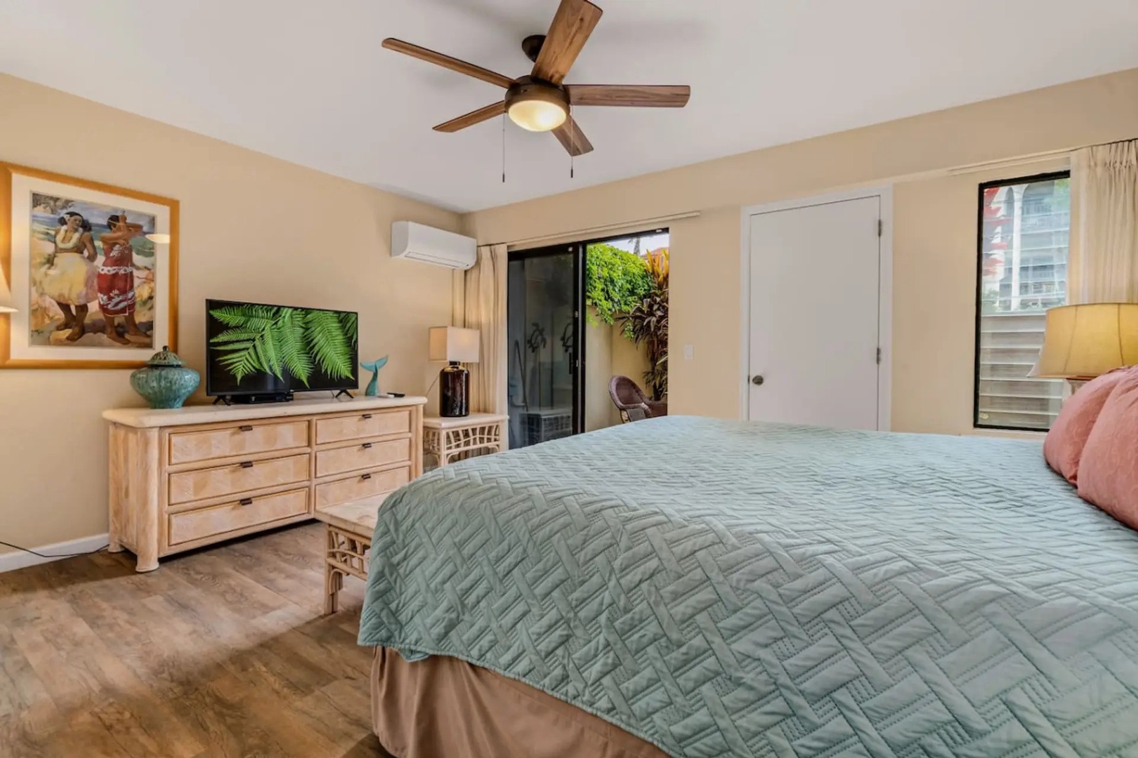 Kihei Vacation Rentals, Maui Kamaole E103 - This king bedroom has its own TV and sliding door out to the lanai.