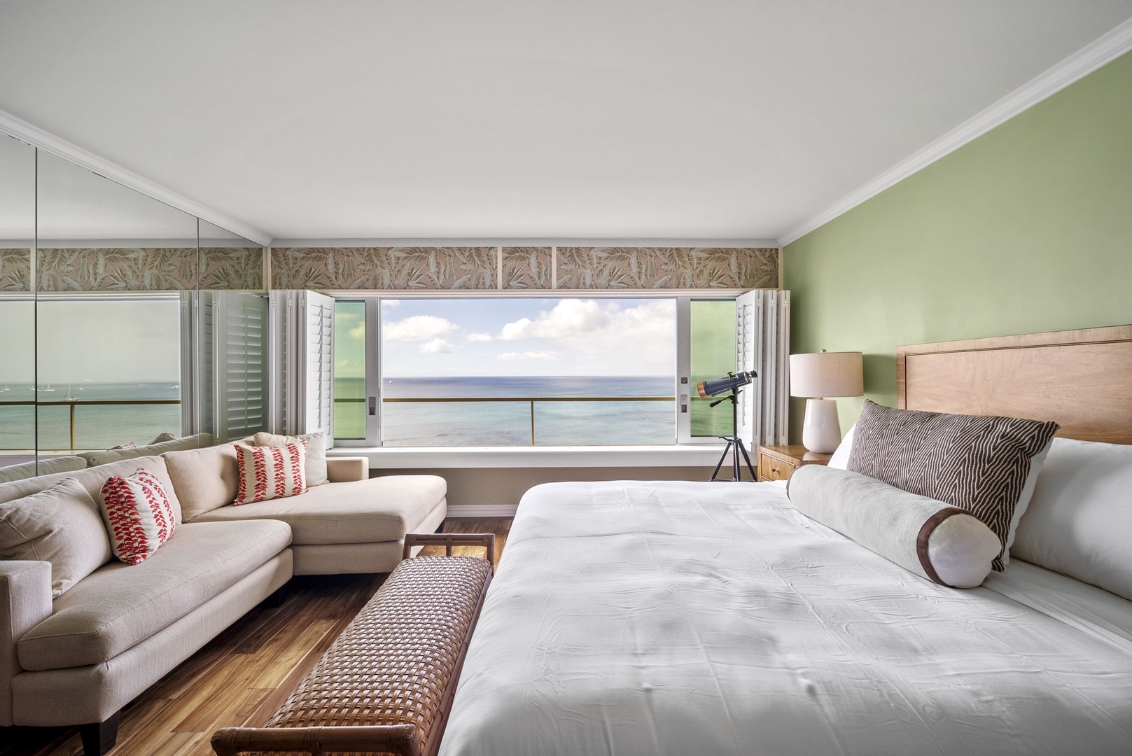 Honolulu Vacation Rentals, Hale Kaimana Breeze - Cozy bedroom with a queen-size bed, seating area, and ocean views.