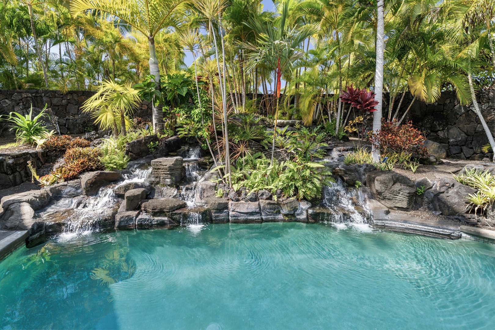 Kailua Kona Vacation Rentals, Mai Tai Manor - Settle into your private tropical oasis with cascading waterfalls and crystal-clear waters surrounded by swaying palms.