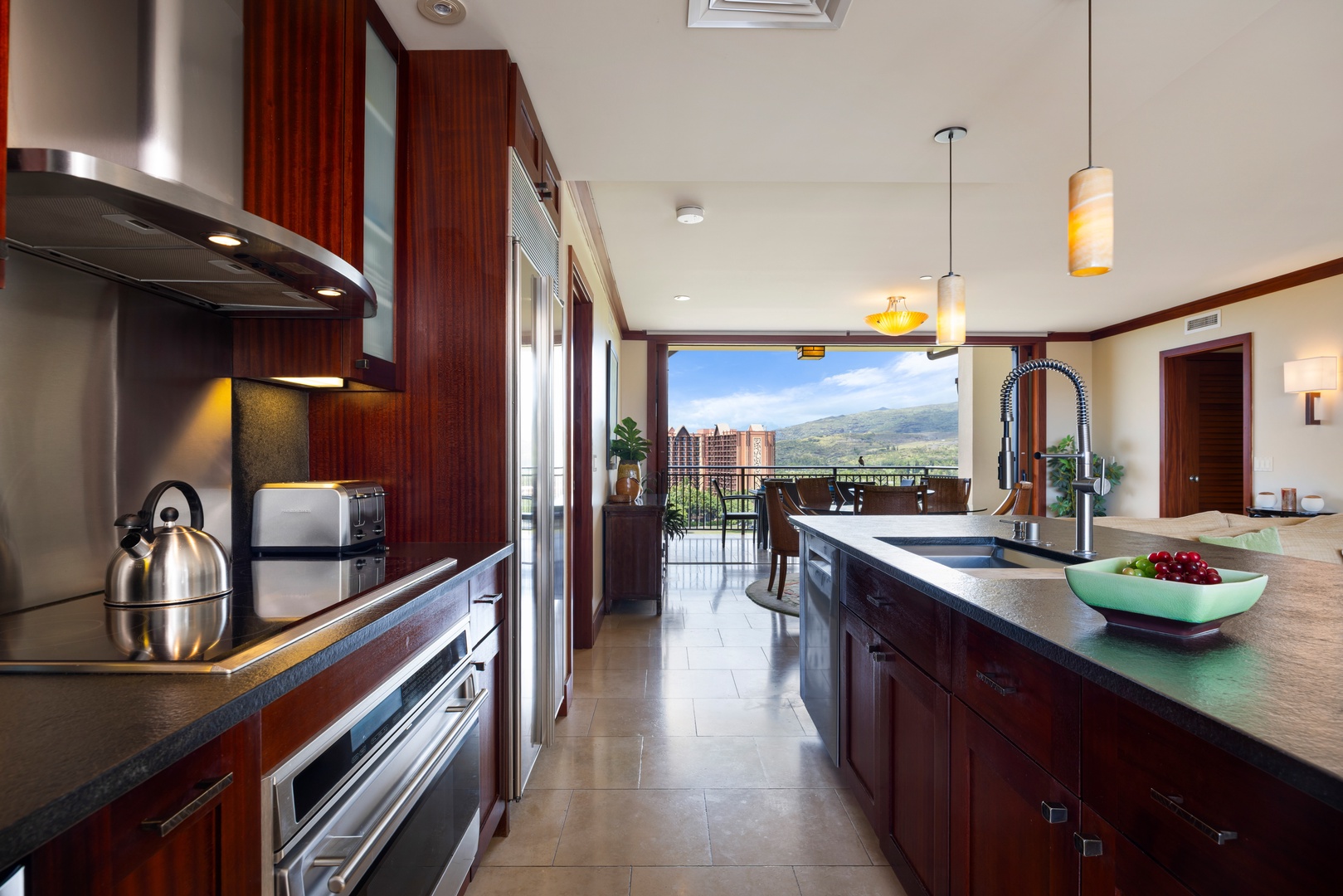 Kapolei Vacation Rentals, Ko Olina Beach Villas O1111 - Cook with stunning mountain views from your gourmet kitchen, featuring rich mahogany cabinets, granite counters, and premium stainless appliances.
