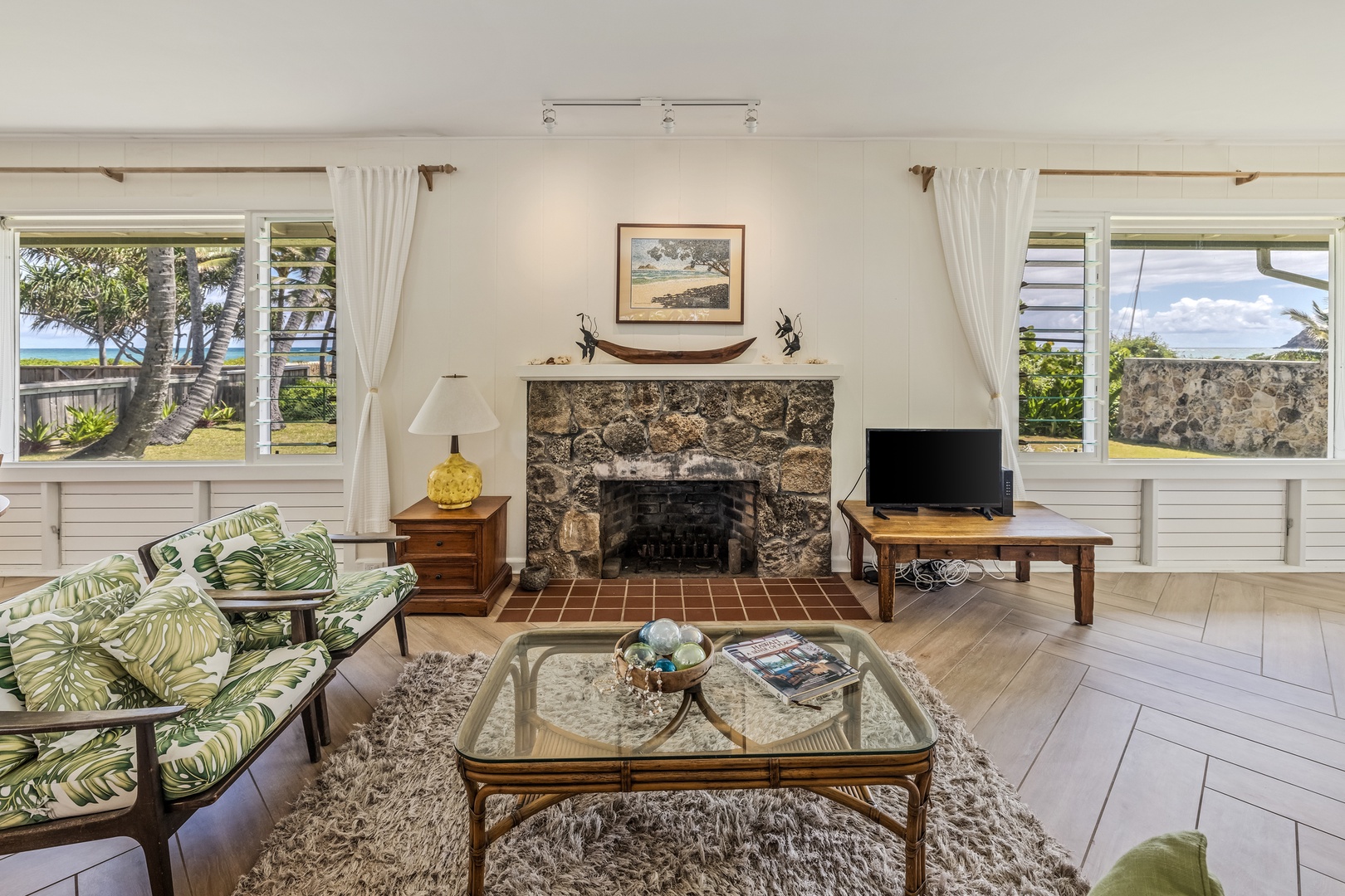 Kailua Vacation Rentals, Hale Moana Lanikai - This elegant living space is centered around a beautifully crafted stone fireplace, creating a warm and inviting atmosphere