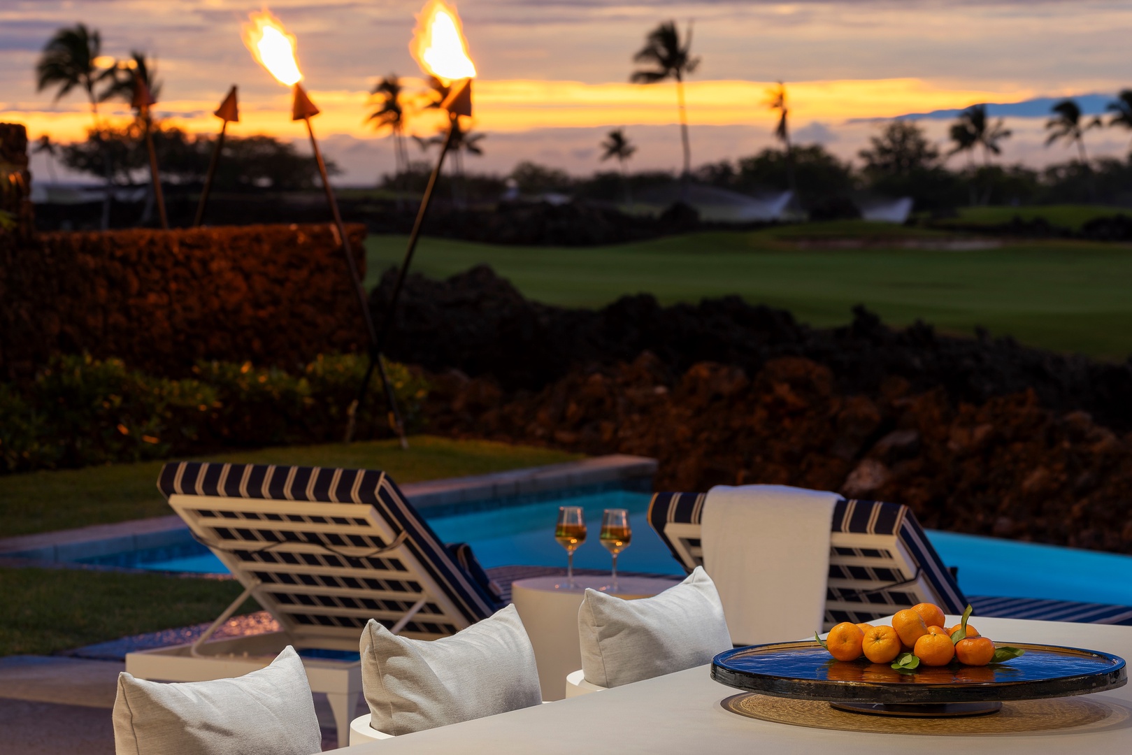 Kamuela Vacation Rentals, 6BD Mauna Lani Lux Golf Estate (6) at One Ocean - Torchlight catches as the sun drops, the pool deck set for a long island evening.