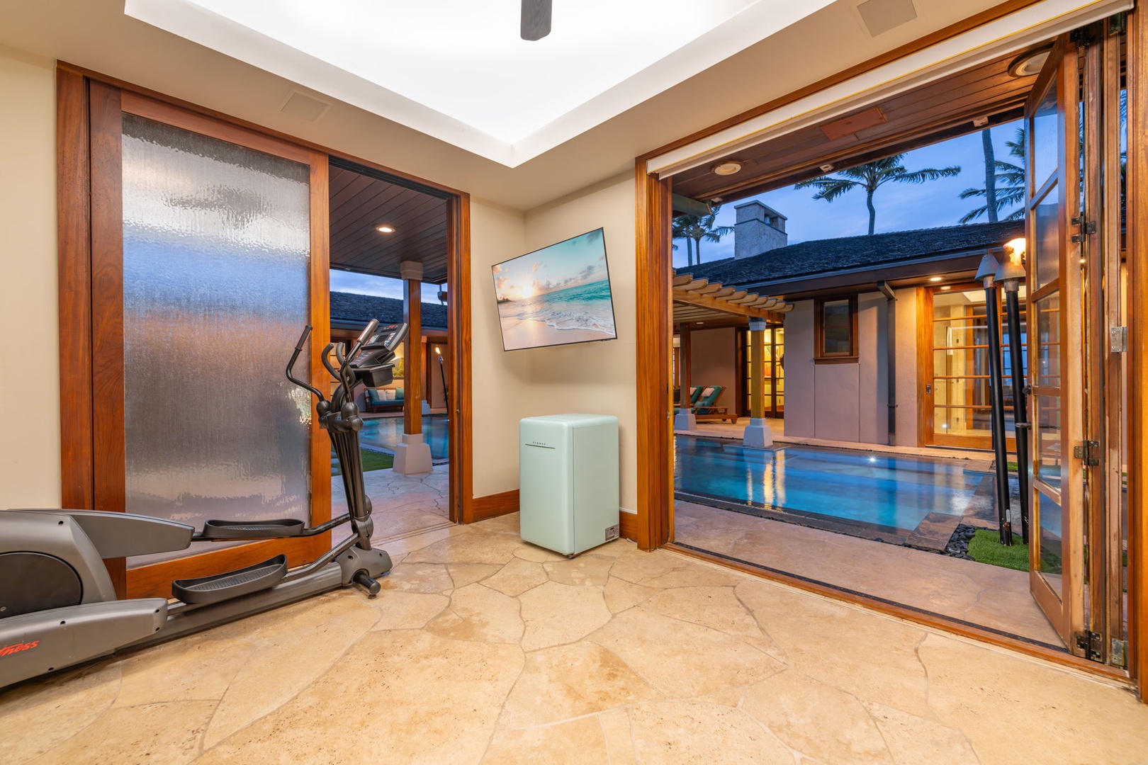 Kailua Vacation Rentals, Kailua Sands - Pool house entry with gym equipment and pool access.