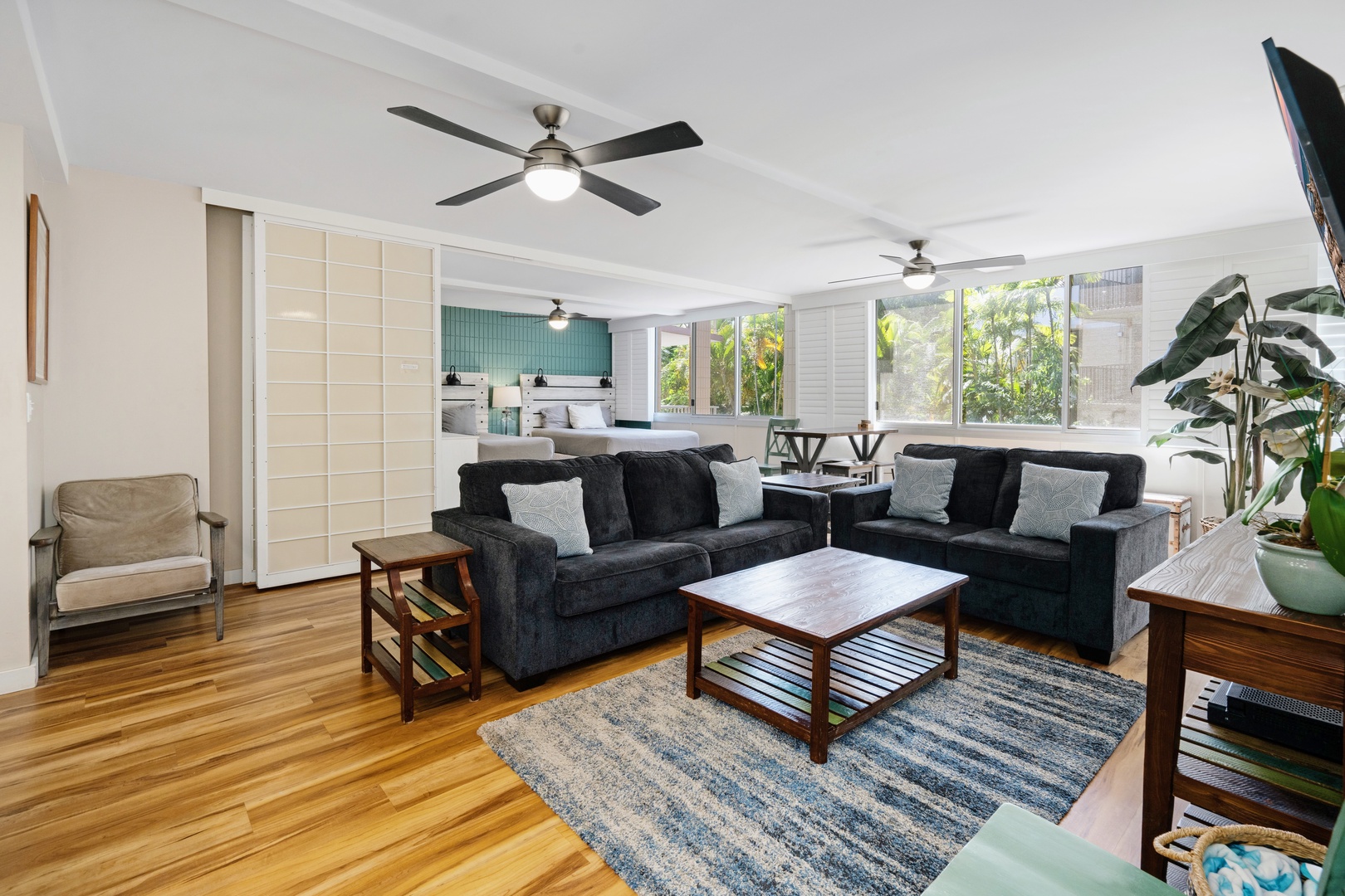 Kihei Vacation Rentals, Haleakala Shores A206 - Two plush sofas and a slatted coffee table anchor the room where the whole group gathers before dinner.