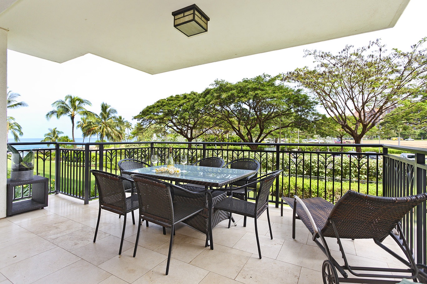 Kapolei Vacation Rentals, Ko Olina Beach Villas B204 - An expansive lanai surrounded by lush green trees.