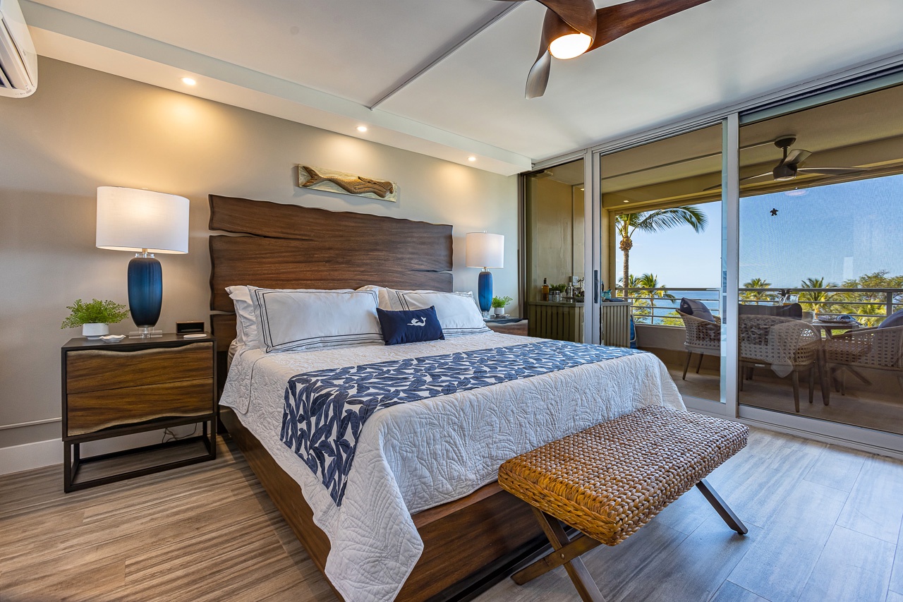 Kihei Vacation Rentals, Kamaole Beach Royal 610 - Ocean and palm fill the primary suite's sliding doors, the first thing this room shows you.