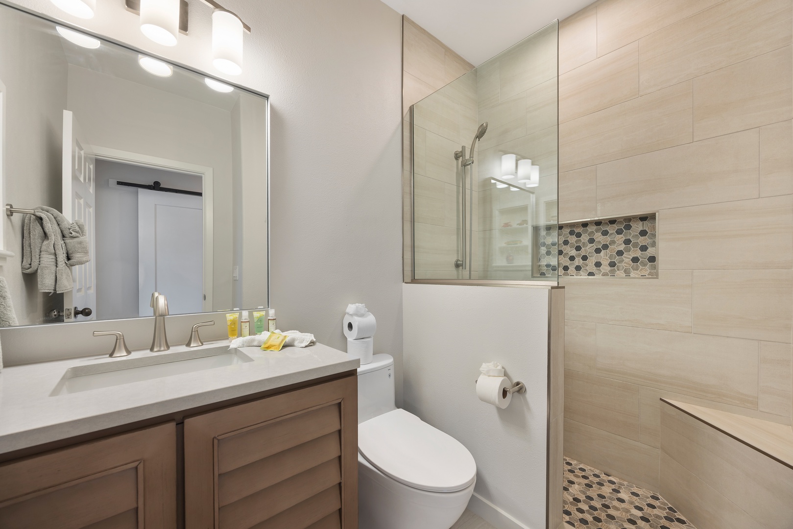 Step into your private spa-style bathroom featuring elegant tile work, modern fixtures, and thoughtful details for your comfort.