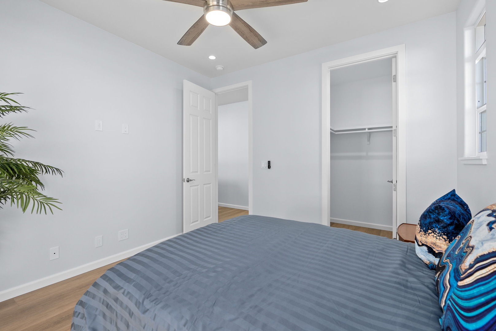 Waianae Vacation Rentals, Oceanfront Luxury Dream Estate - Spacious third suite with ceiling fan, built-in closet storage, and crisp white walls for a clean, airy vibe.