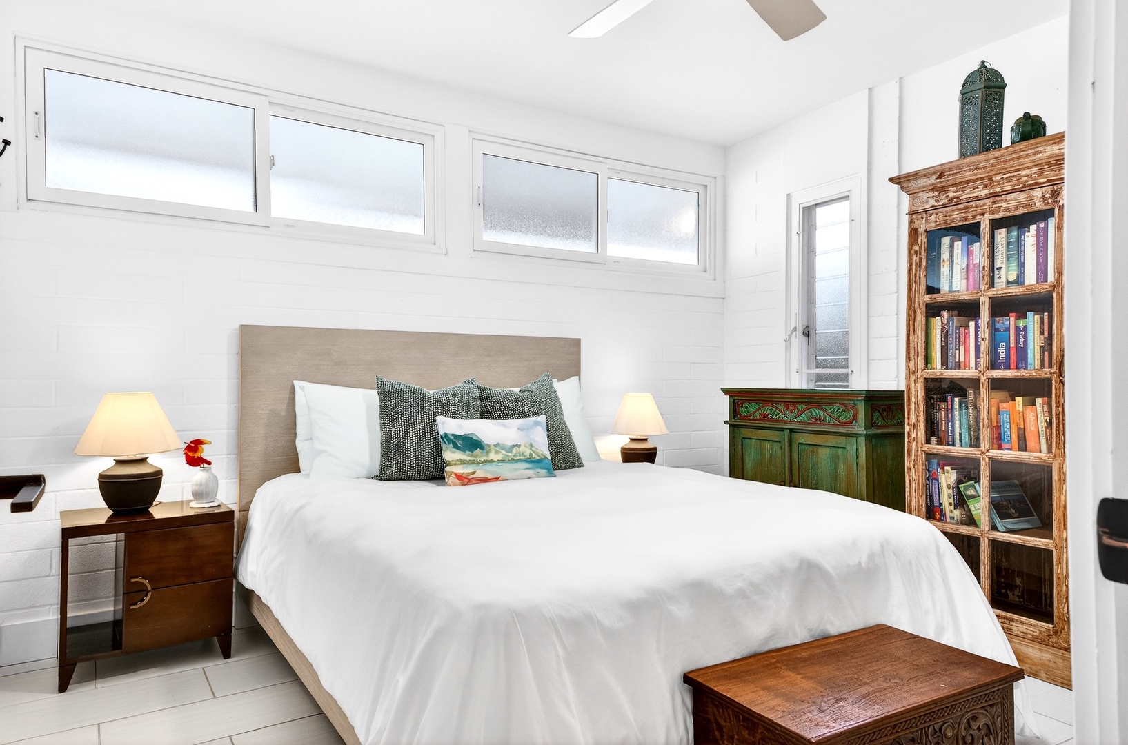 Kailua Vacation Rentals, Hale Ohana - Sink into crisp white linens and let natural light brighten your mornings in this serene bedroom with curated books at your bedside.