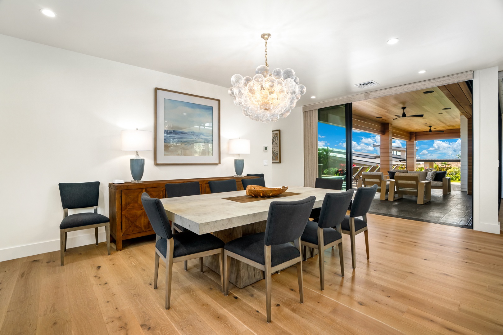 Koloa Vacation Rentals, Hale Laule'a at Kukui'ula - Gather around your elegant dining table for memorable meals under a stunning bubble chandelier, with beautiful outdoor living seamlessly extending your space.