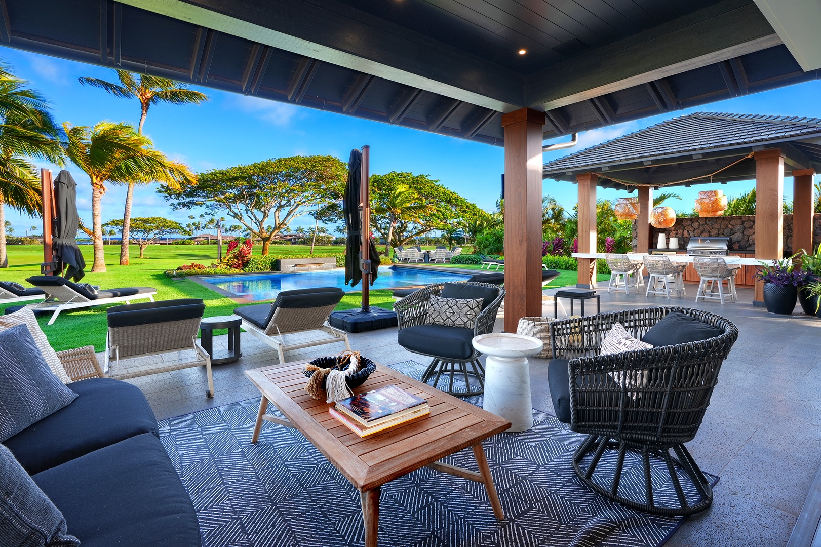 Koloa Vacation Rentals, Hale Pakika at Kukui'ula - Lounge in comfort on the shaded lanai with ocean views and a serene poolside setting.