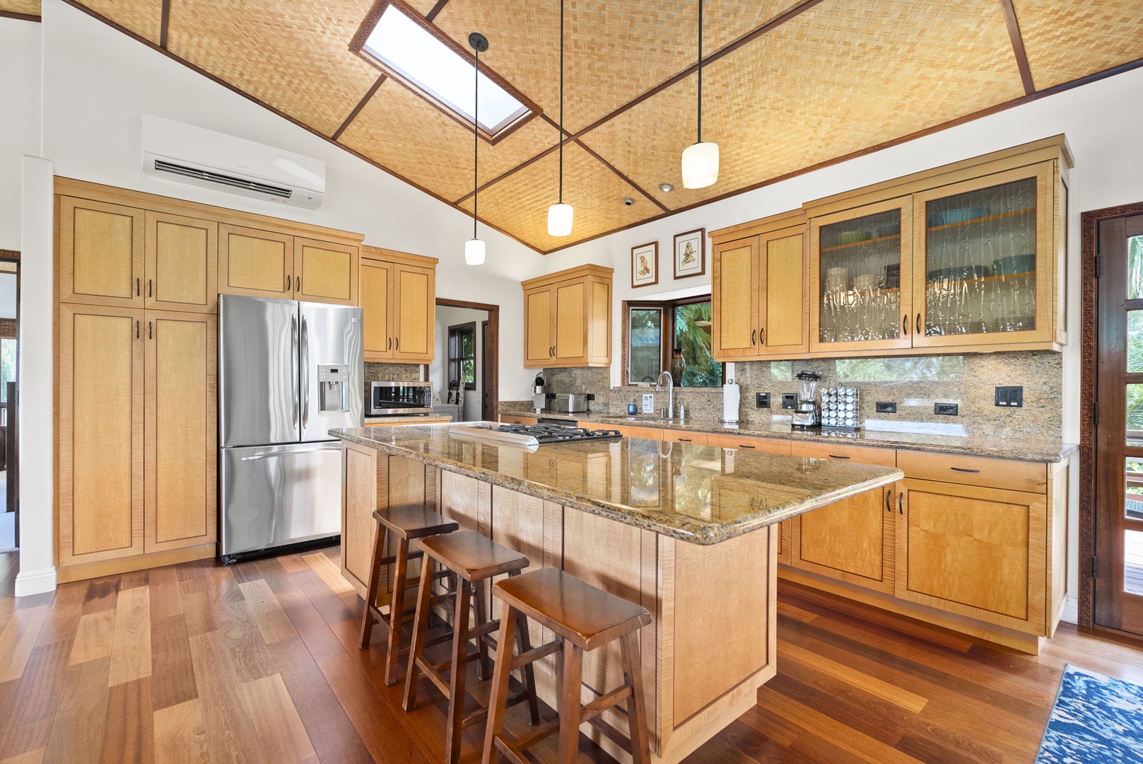 Haleiwa Vacation Rentals, Kealoha Tropical Beach Villa - The gourmet kitchen features wide countertops, stainless steel appliances, split AC, and bar seating for three.