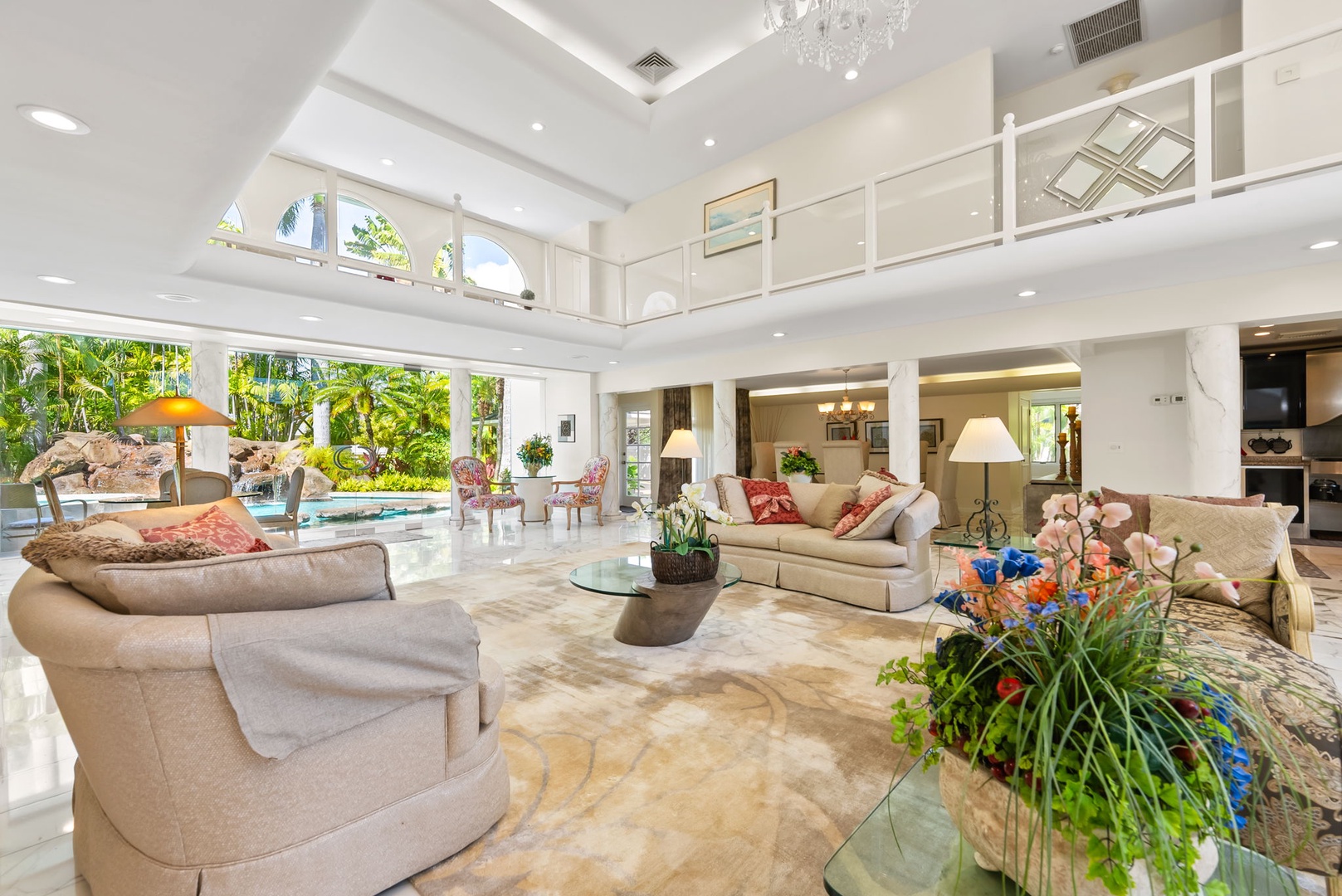 Honolulu Vacation Rentals, Kahala Oasis - Expansive living room with high ceilings, elegant decor, and garden views, creating a luxurious and inviting space.