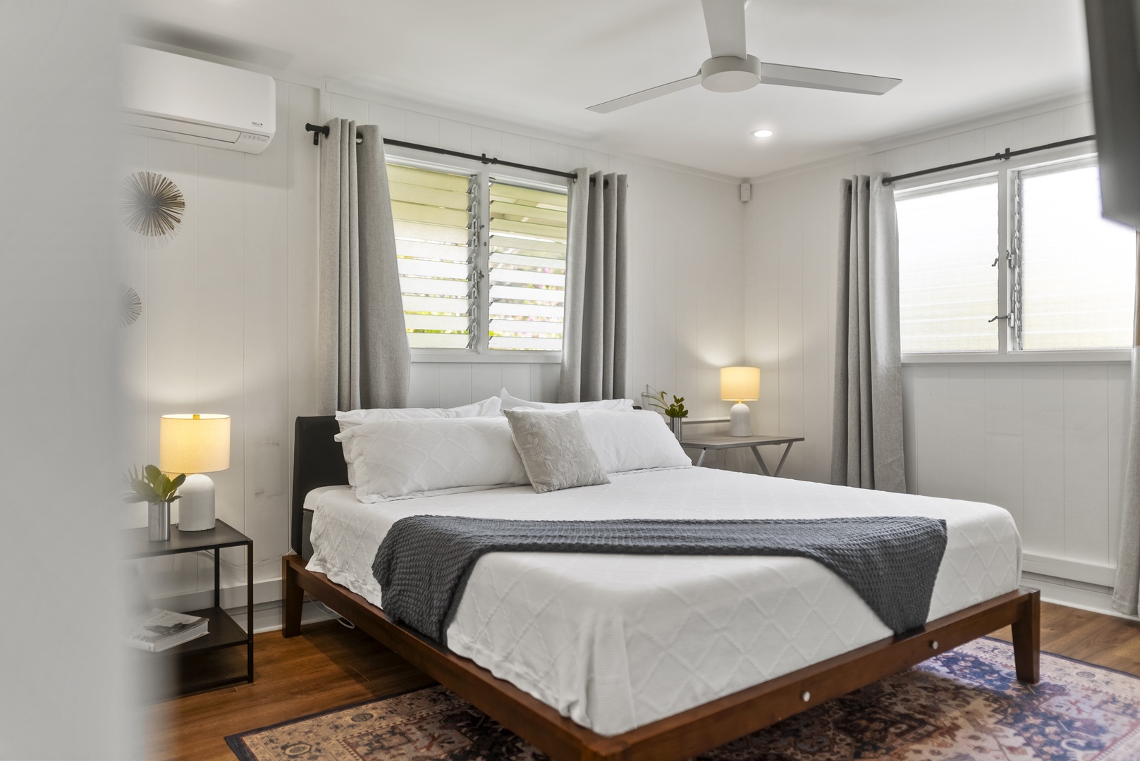 Honolulu Vacation Rentals, Honolulu Beachfront Retreat - Coastal-inspired bedroom with a plush king-sized bed, light linens, and soft island breezes just outside the window.