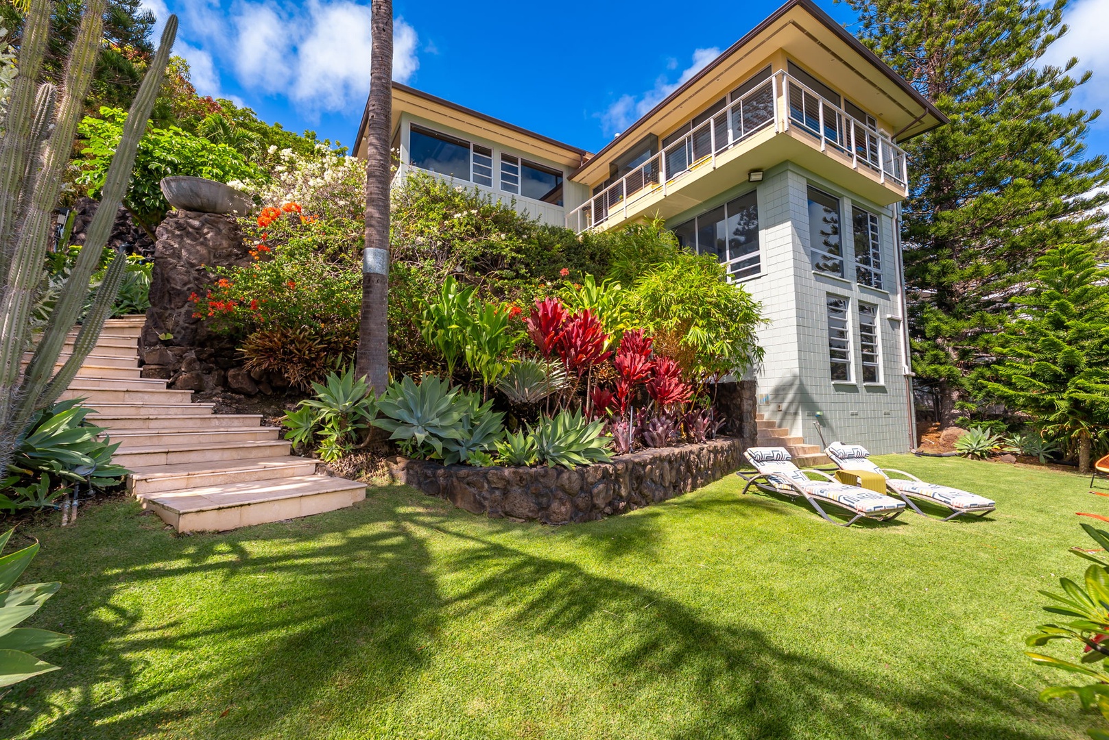 Honolulu Vacation Rentals, Kahala Hills Estate - Tiered landscaping with tropical blooms surrounds the estate, adding lush privacy and color.