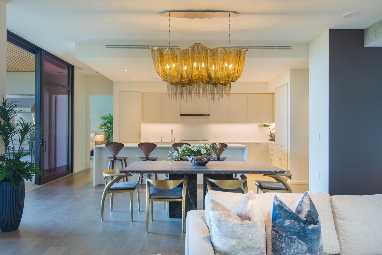 Honolulu Vacation Rentals, Park Lane Sunset Resort - Step into your sophisticated open-plan space where golden light cascades from the stunning chandelier over your elegant dining table.