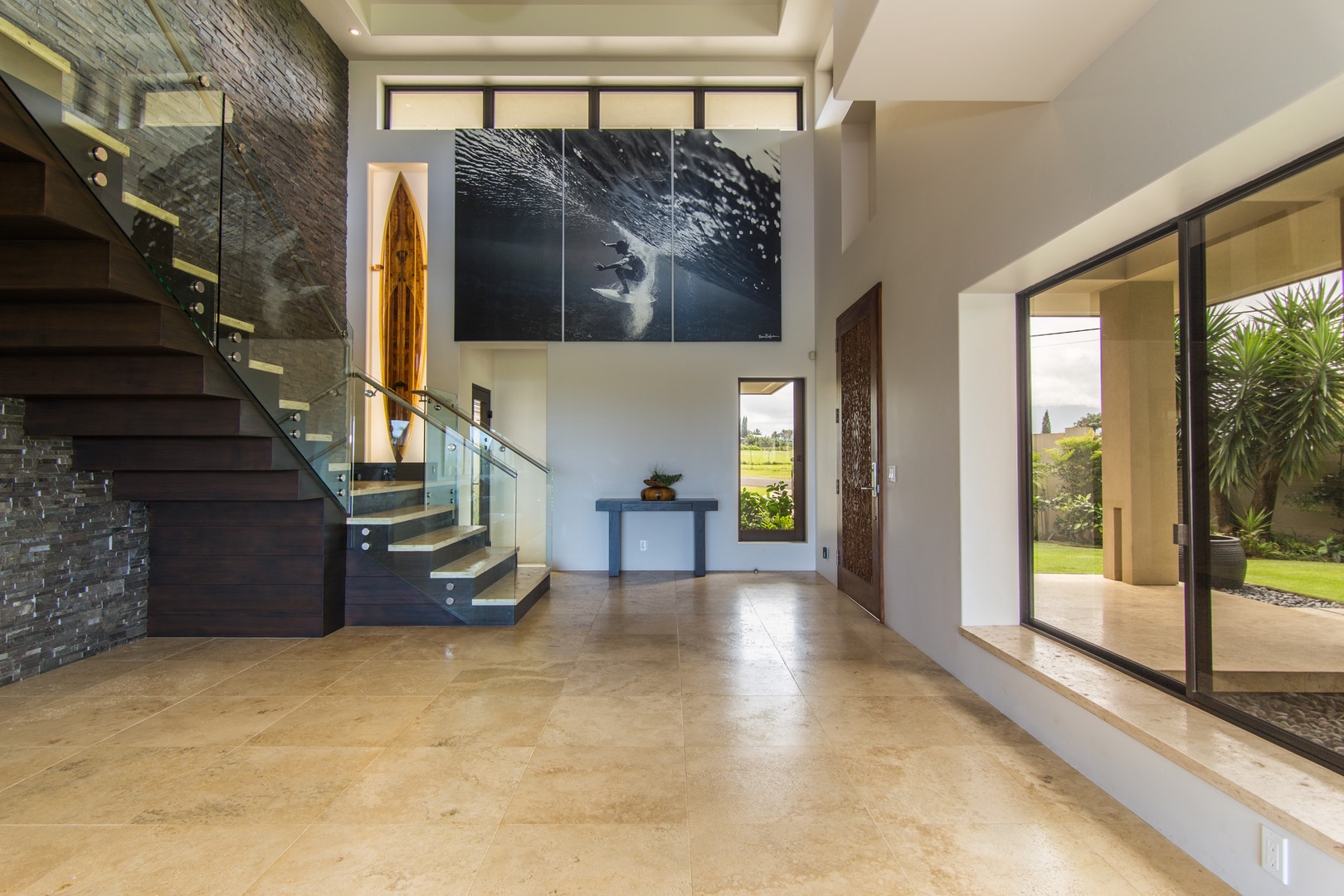 Princeville Vacation Rentals, Hanalei Plantation Villa - Elegant entryway with a modern staircase, welcoming guests into the villa’s open and spacious layout.