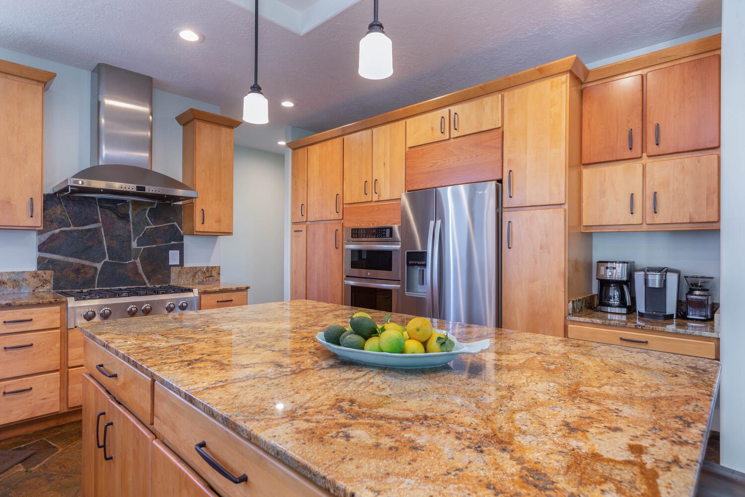 Princeville Vacation Rentals, Pohaku Villa - The kitchen features stainless steel appliances and ample cabinetry for storage.