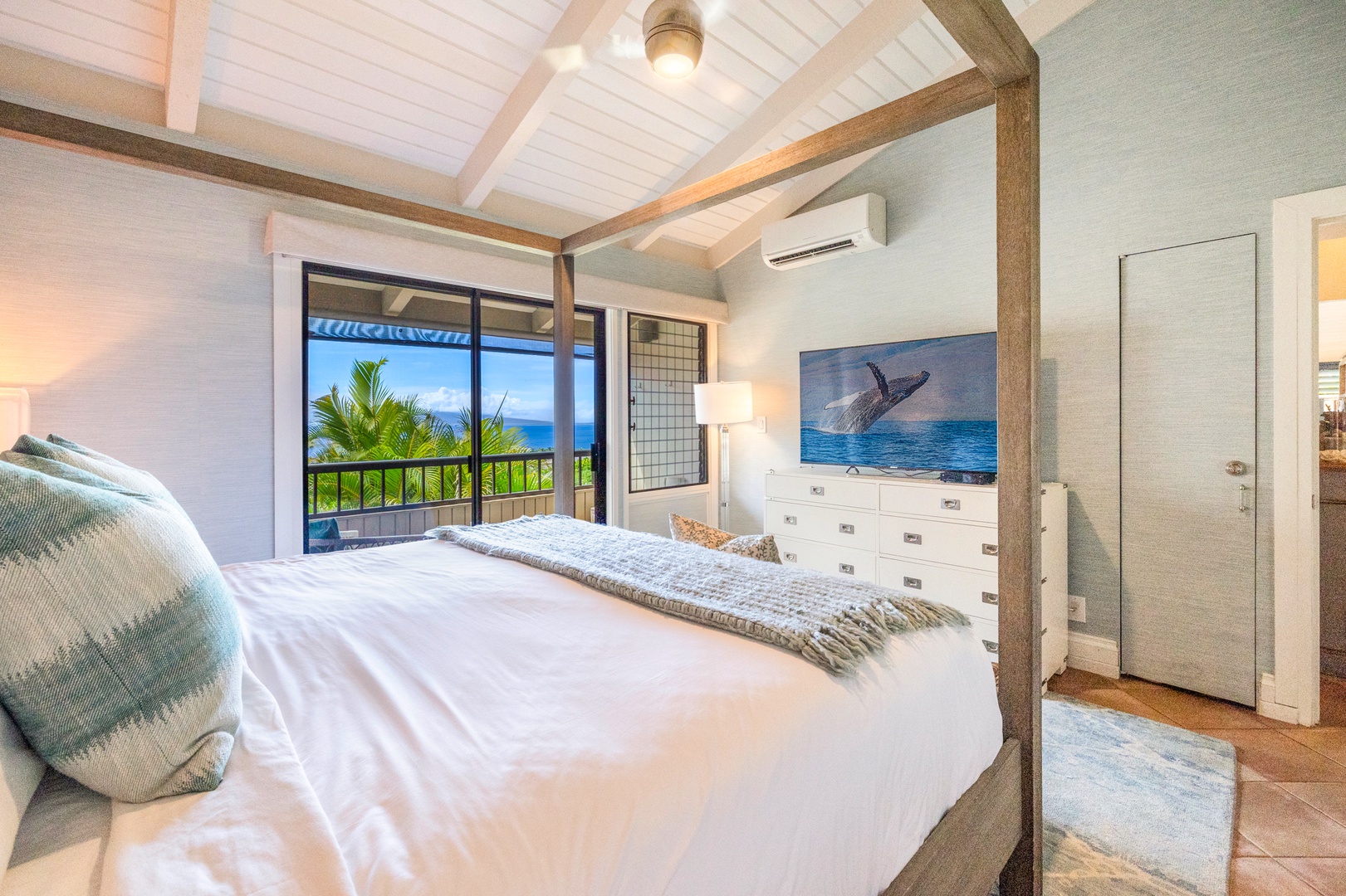 Kihei Vacation Rentals, Wailea Ekolu 1106 - This cozy bedroom features a luxurious canopy bed with soft drapery, perfect for enjoying a peaceful night's sleep while soaking in the fresh island air from the nearby lanai.