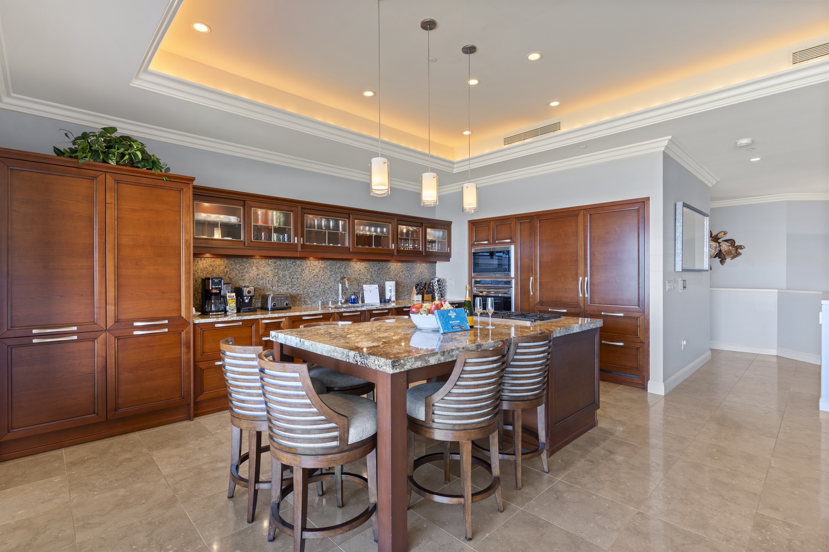 Wailea Vacation Rentals, Wailea Luxury Residence Hoolei 23-3 - The gourmet kitchen boasts a large island with seating, perfect for casual dining or enjoying a glass of wine..