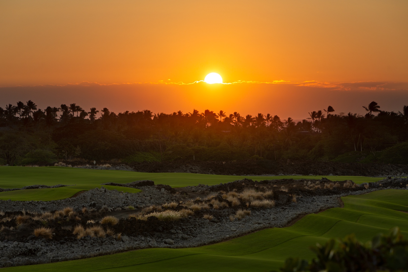 Kailua Kona Vacation Rentals, 3BD Waiulu Villa (111D) at Hualalai Resort - Spectacular sunset over pristine golf course with tropical palm trees creating a dramatic Hawaiian landscape backdrop.