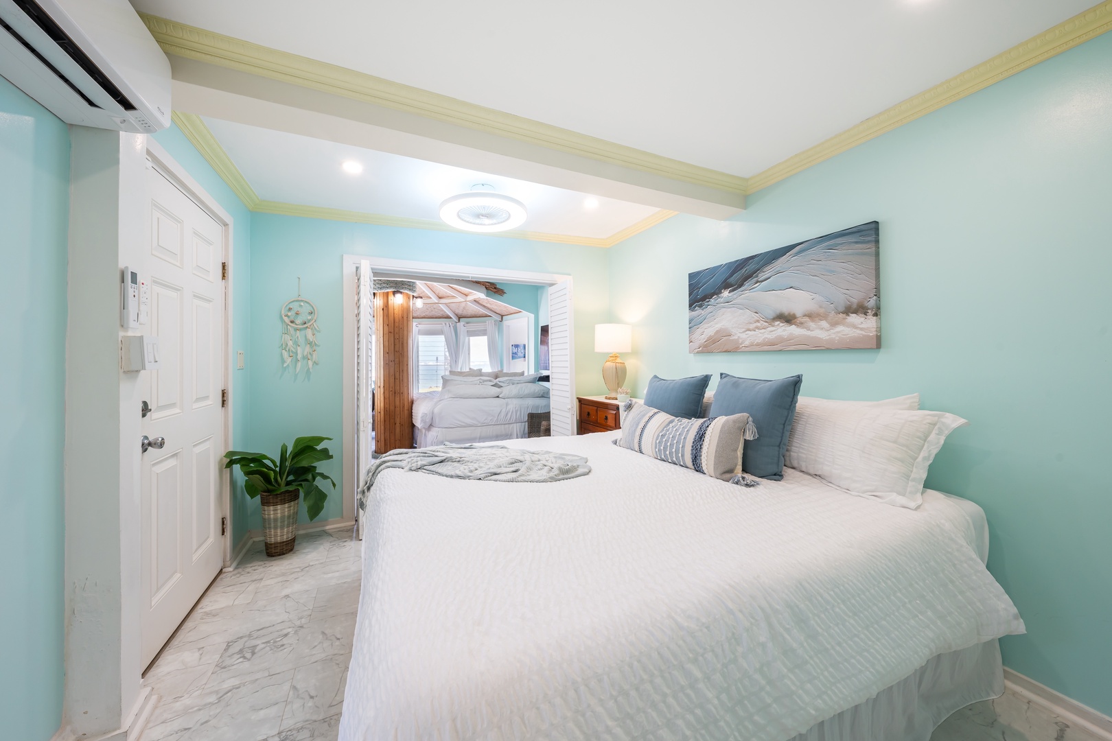 Hauula Vacation Rentals, Private Beach Paradise - White bedding and its own split A/C in a bright, easy guest room.