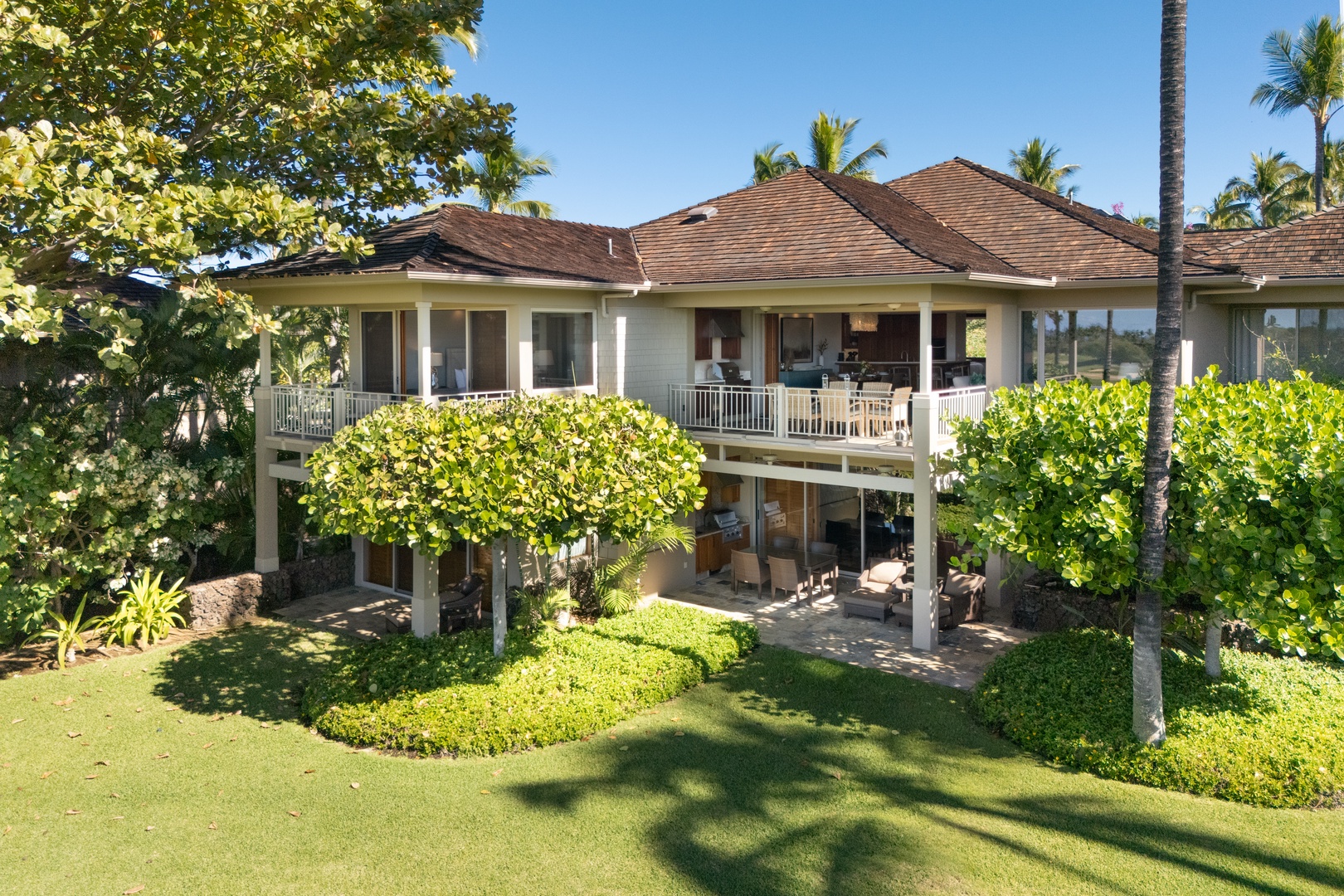 Kailua Kona Vacation Rentals, 3BD Waiulu Villa 111D at Hualalai Resort - Picturesque villa with a charming exterior nestled in lush surroundings.