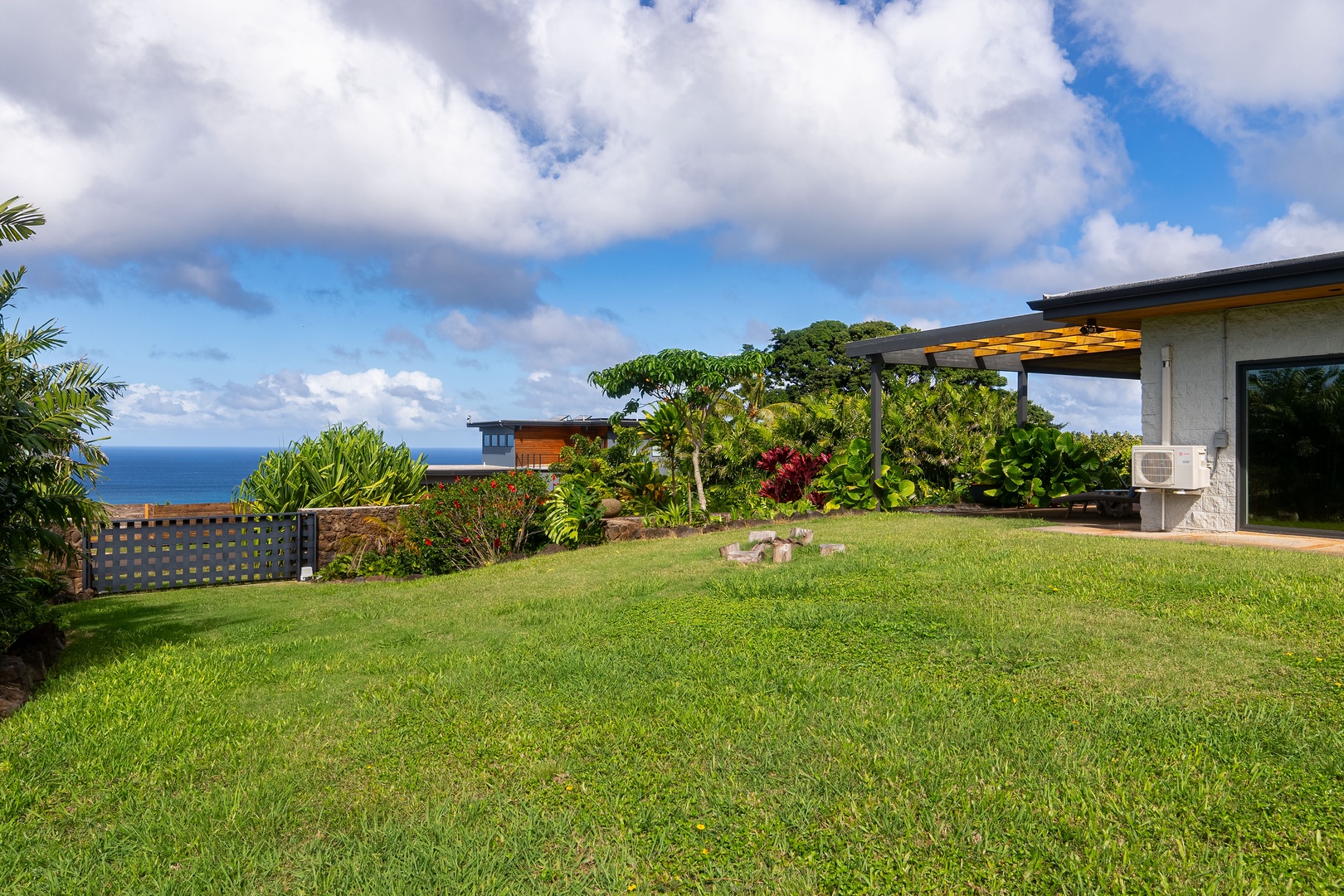 Haleiwa Vacation Rentals, Hale Mahina - Play or unwind on the expansive grassy lawn surrounded by tropical landscaping.