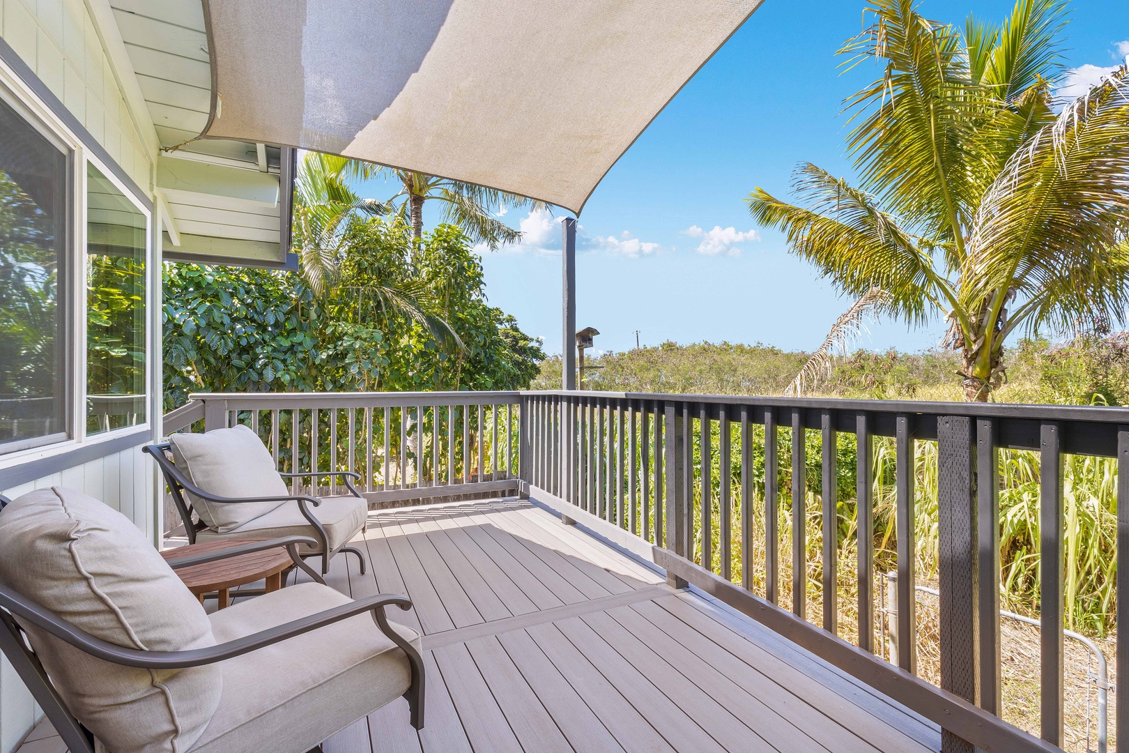 Haleiwa Vacation Rentals, Velzey Ohana Villa (4B Vacation Home) - Relax on the shaded lanai with cozy lounge chairs and a peek at the tropical treetops.