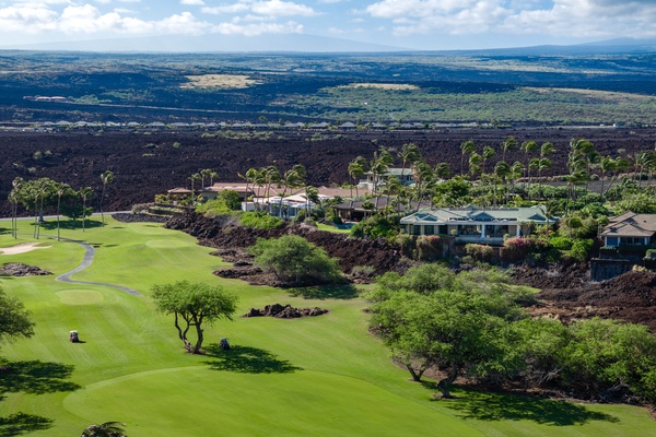 Kamuela Vacation Rentals, Canoe House & Beach Walker at Champion Ridge - Aerial view of Canoe House at Champion Ridge, a luxurious home set along a scenic golf course, surrounded by lush greenery and offering expansive views of the landscape.