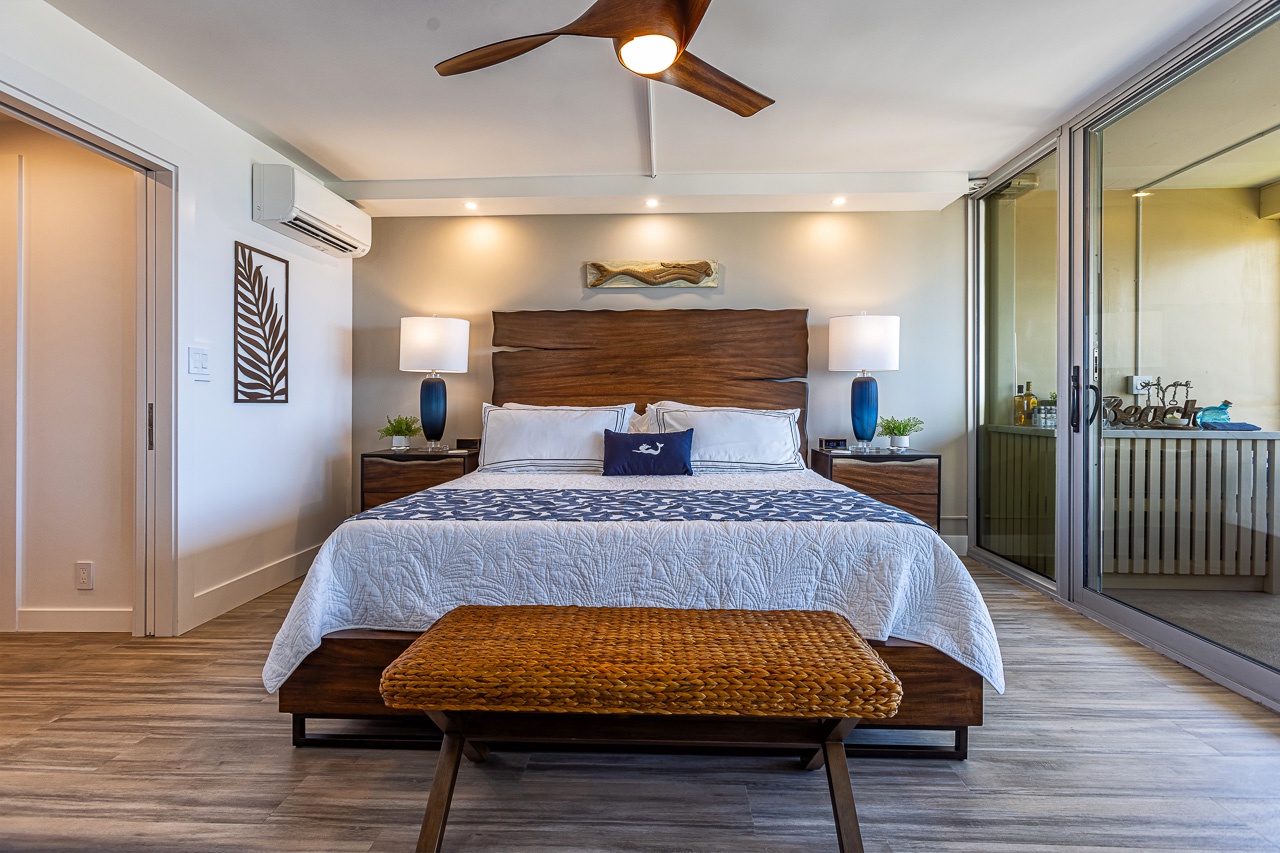 Kihei Vacation Rentals, Kamaole Beach Royal 610 - The primary suite's king bed sits next to its own sliding doors onto the lanai.