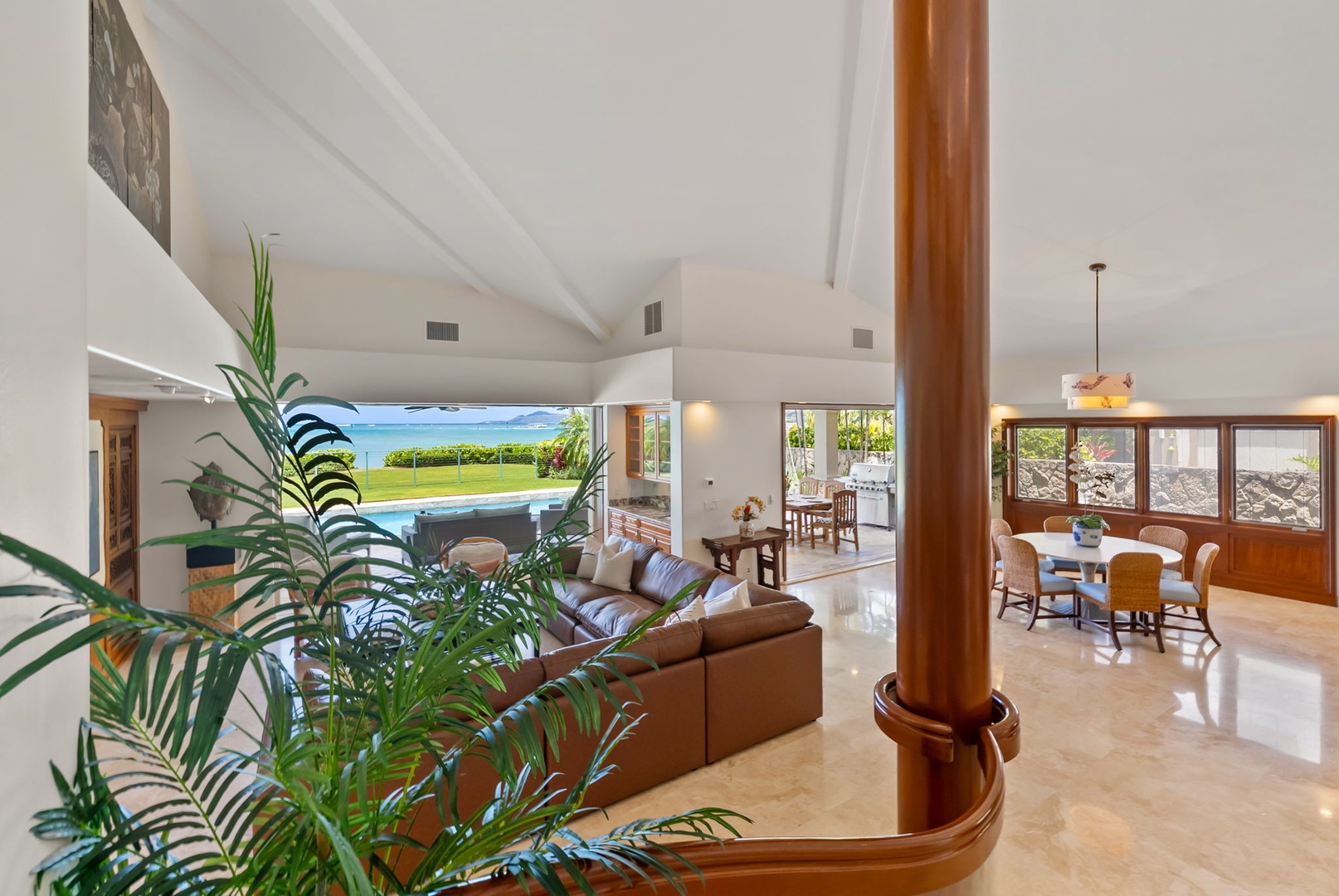Honolulu Vacation Rentals, Maunalua Estate - Open living spaces extend toward the pool and lawn, framed by sweeping ocean views.