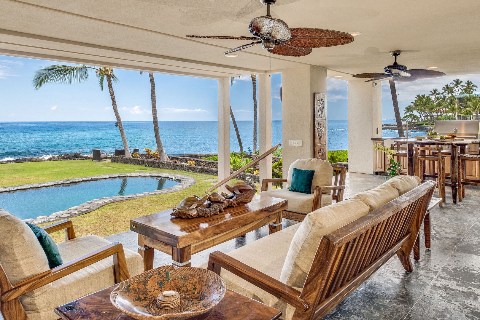 Kailua Kona Vacation Rentals, Kona Beach Bungalows** - Relax on the Moana Lanai, where serene pool and ocean views await your gaze.