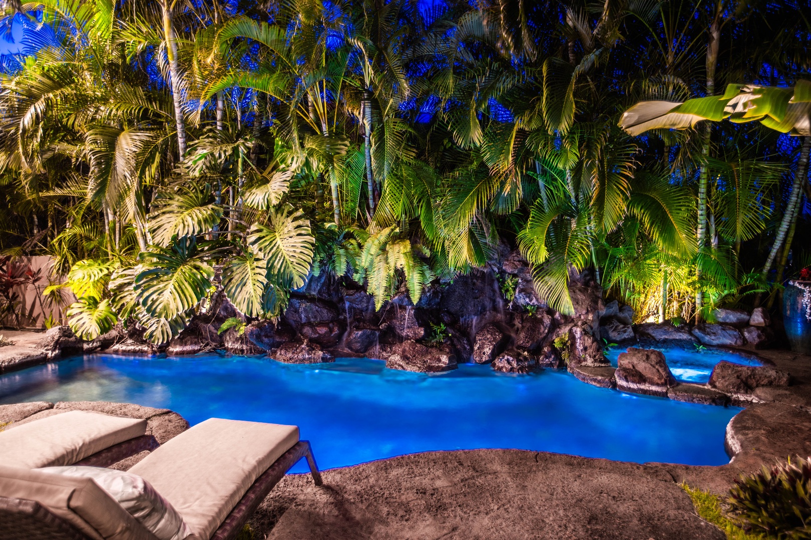 Honolulu Vacation Rentals, Pili Pono - Evening ambiance with dramatic lighting and lava rock accents.