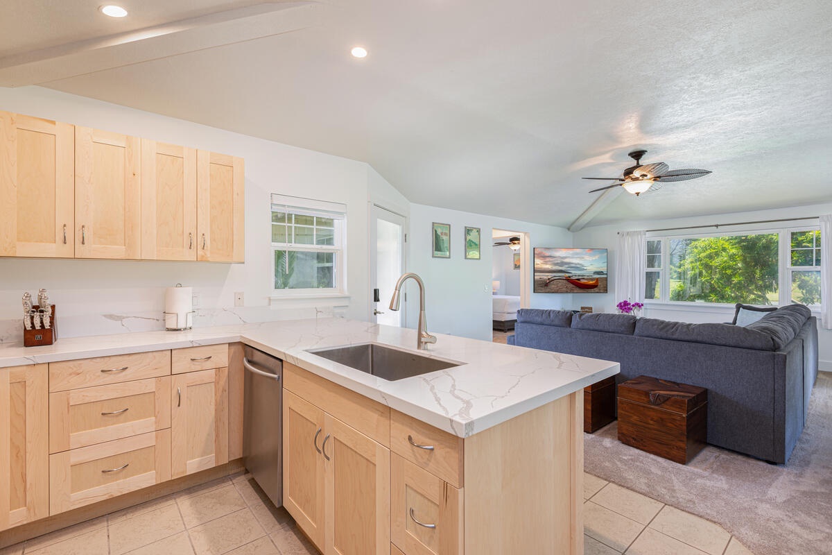 Princeville Vacation Rentals, Pili Aloha - Functional kitchen with island seating and open flow into the living space.