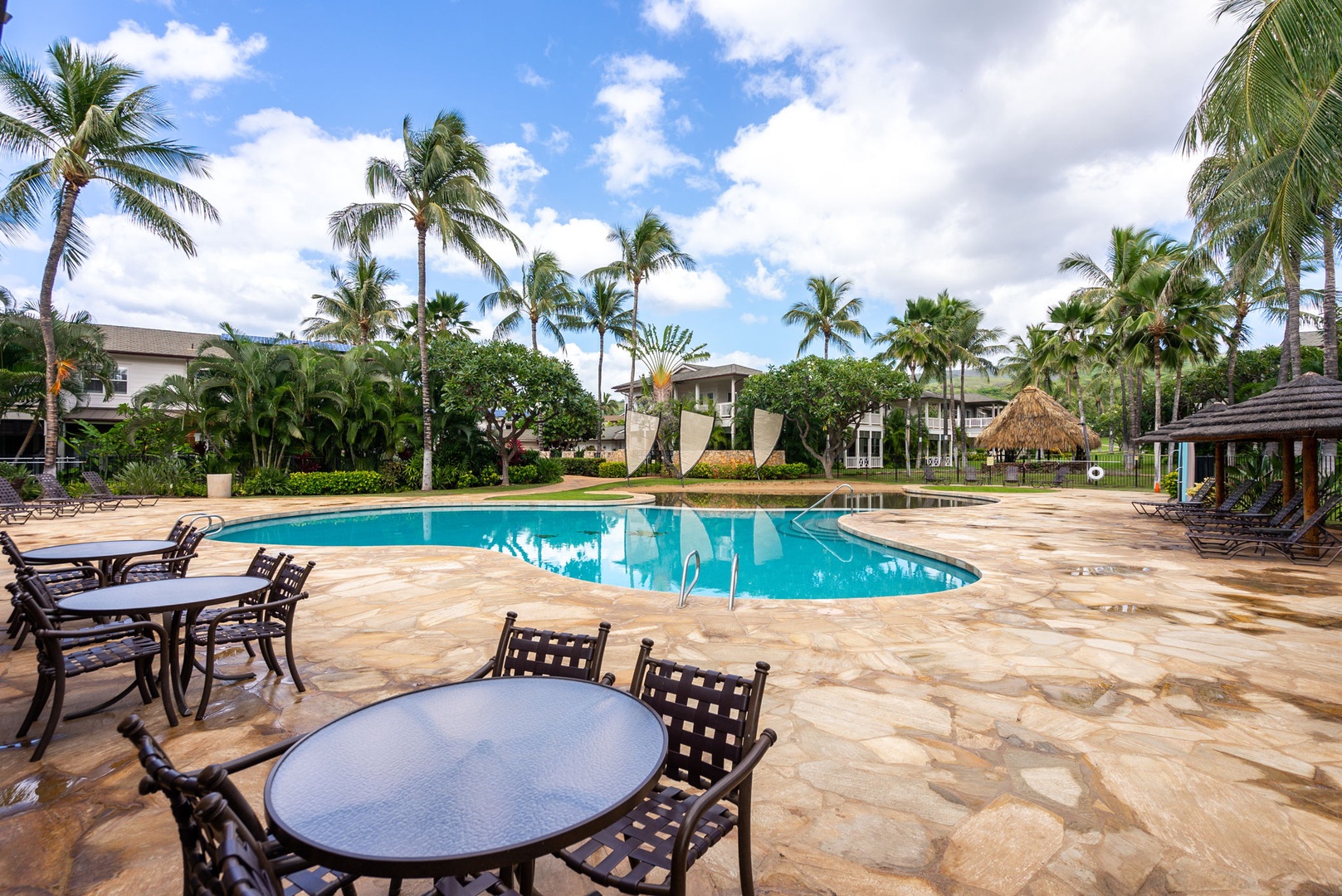 Kapolei Vacation Rentals, Coconut Plantation 1080-4 - Shade umbrellas and poolside tables for a long lunch between swims.