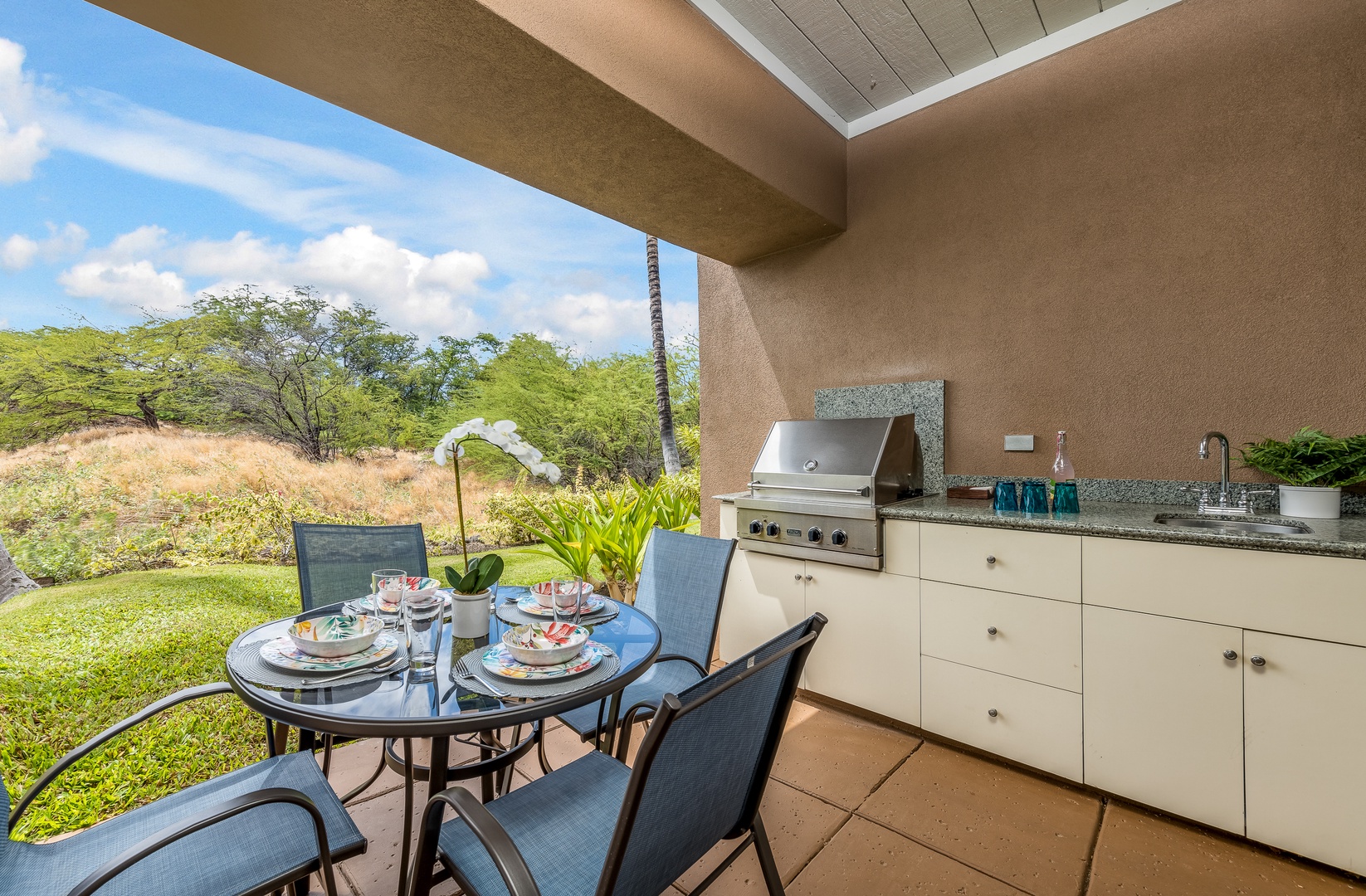 Kamuela Vacation Rentals, Mauna Lani Fairways #603 - Al fresco dining on the patio, surrounded by native landscape views.