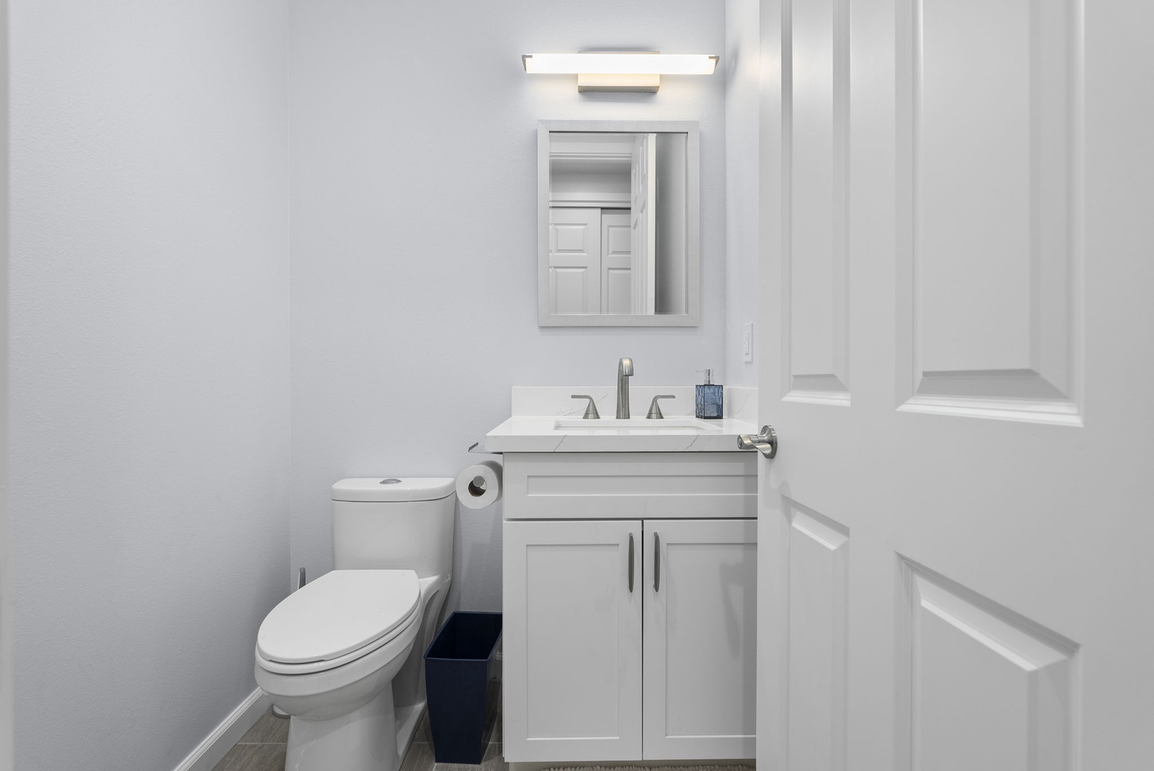 Waianae Vacation Rentals, Oceanfront Luxury Dream Estate - Convenient half bath with modern fixtures, perfect for daytime guests and shared living areas.