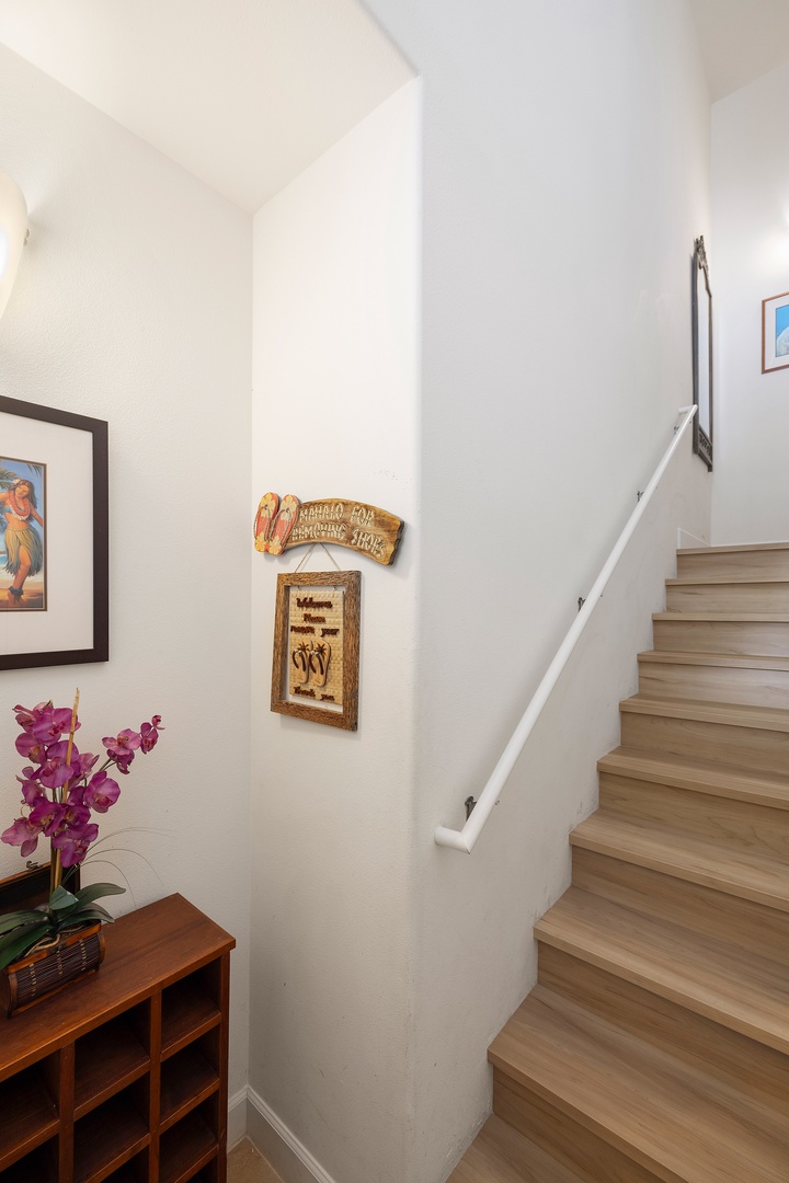 Kapolei Vacation Rentals, Ko Olina Kai 1105E - Bright stairway with vaulted ceilings welcomes you upstairs, decorated with colorful artwork and vibrant orchids that bring warmth and charm to your vacation home.