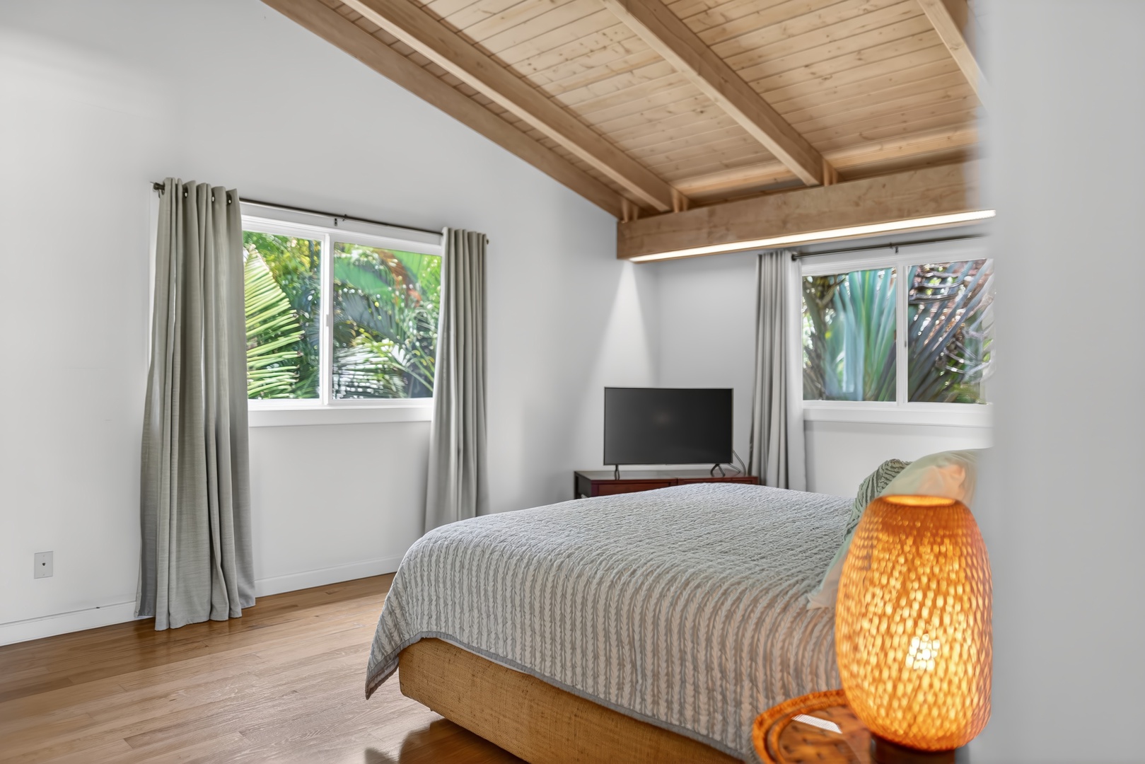 Haleiwa Vacation Rentals, Sunset Beach Hideaway - Enjoy quiet evenings in the comfortable bedroom with TV and garden-facing windows.