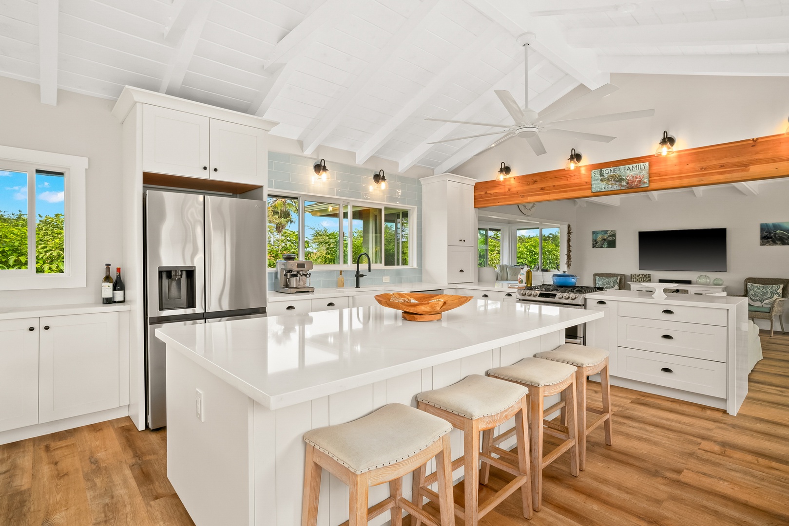 Princeville Vacation Rentals, Ola Hou - Entire Property - A kitchen island with seating invites casual meals and conversation, surrounded by bright, airy space.