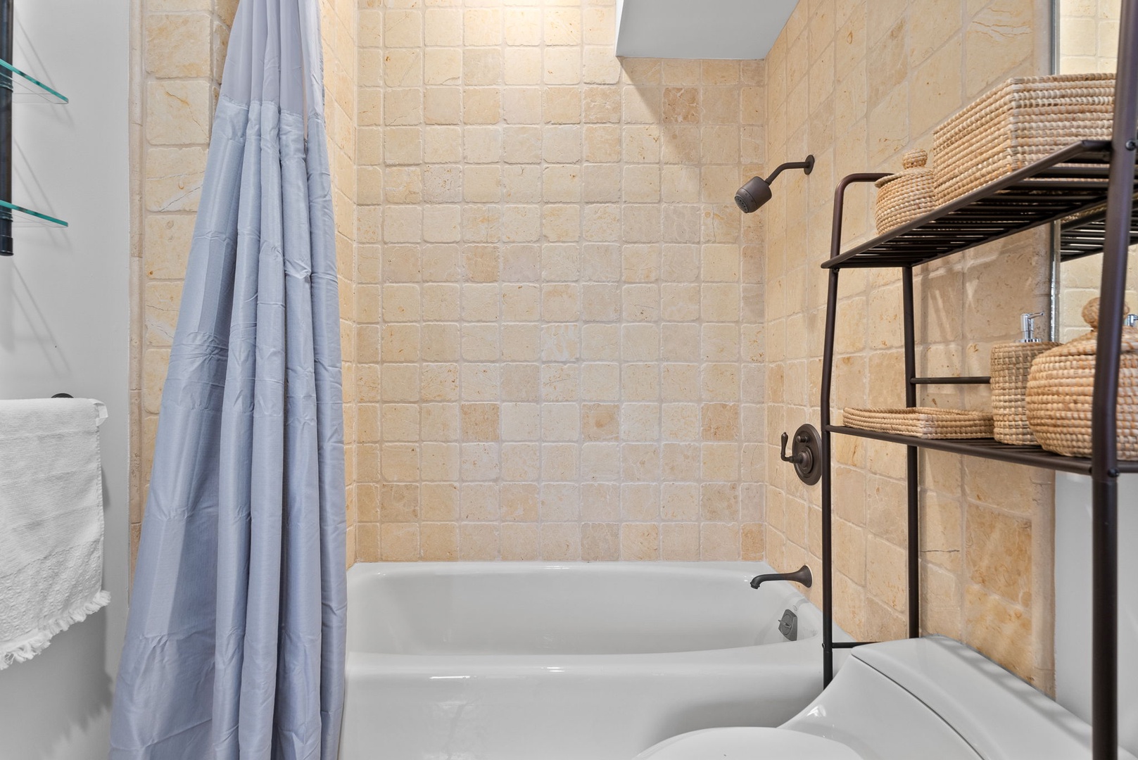 Honolulu Vacation Rentals, Honolulu Lagoonfront Villa - Natural stone tile and warm finishes lend this guest bath an inviting, spa-like feel.